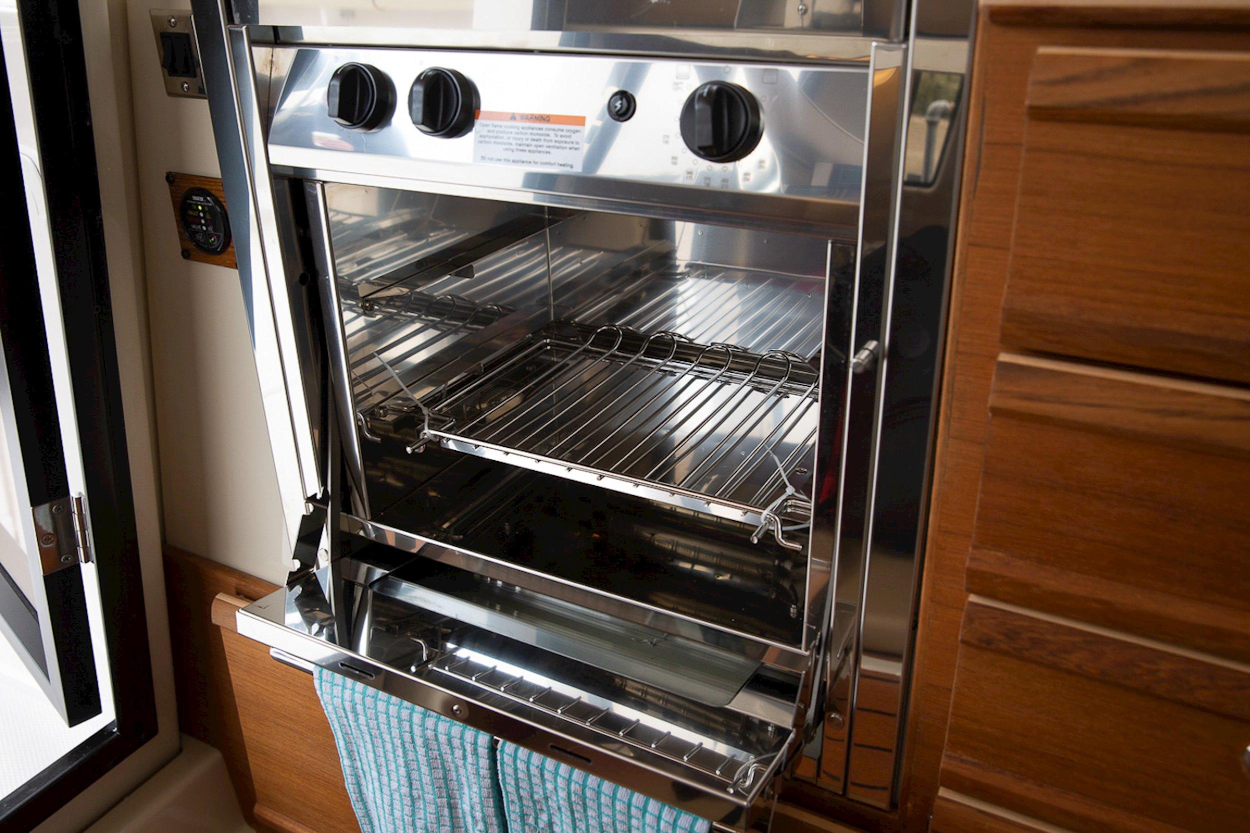 Interior of a 2019 Ranger Tugs R-27 featuring a stainless steel oven.