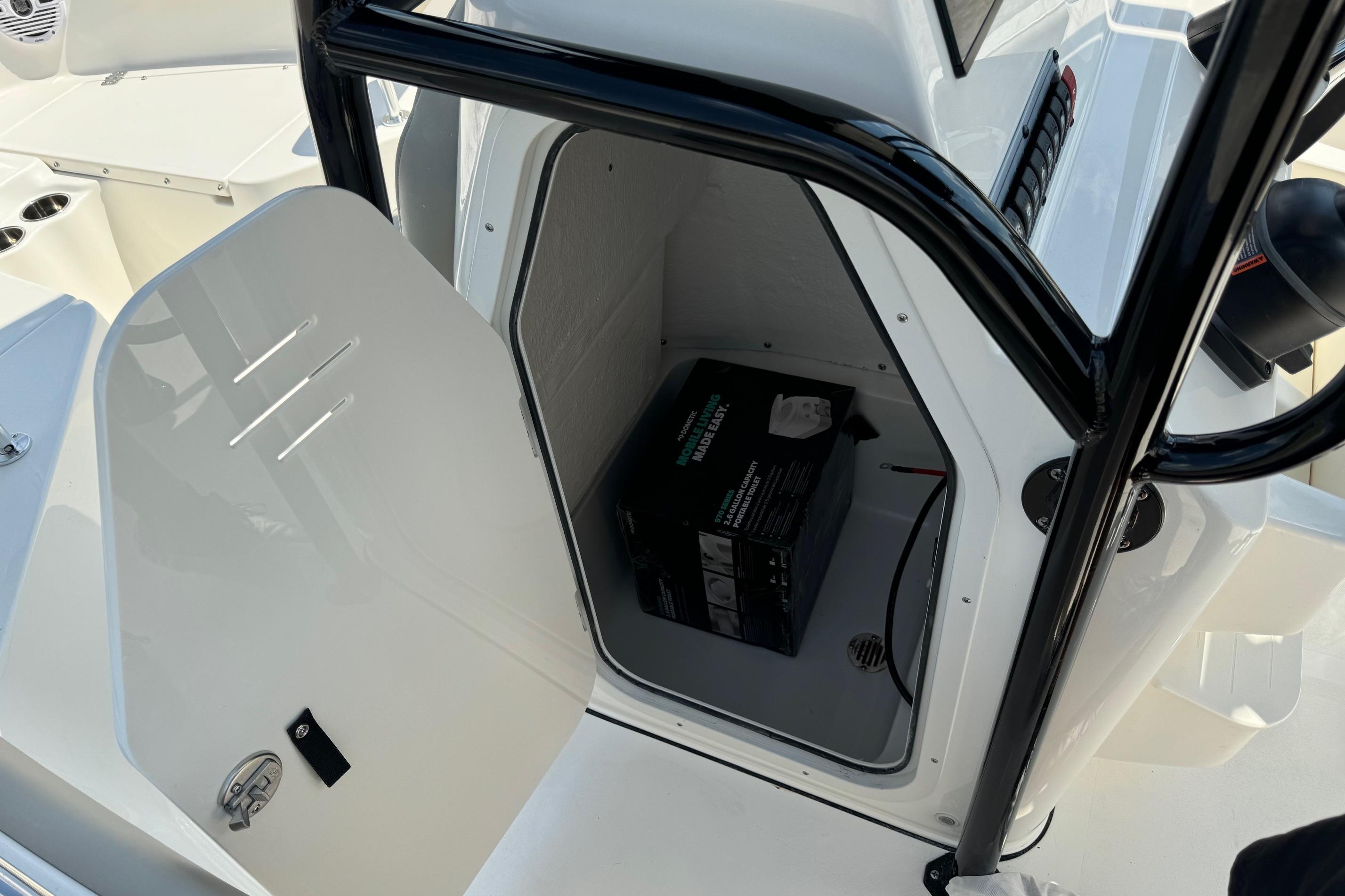 2025 Key West 203 FS boat storage compartment with open door, showing interior space.