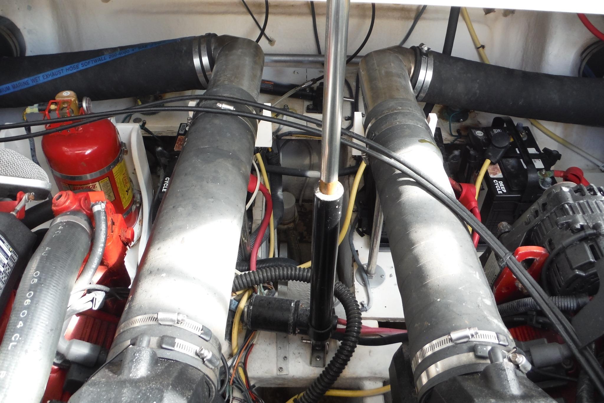 Engine compartment of a 2005 Chaparral Signature 350 boat, featuring hoses and wiring.