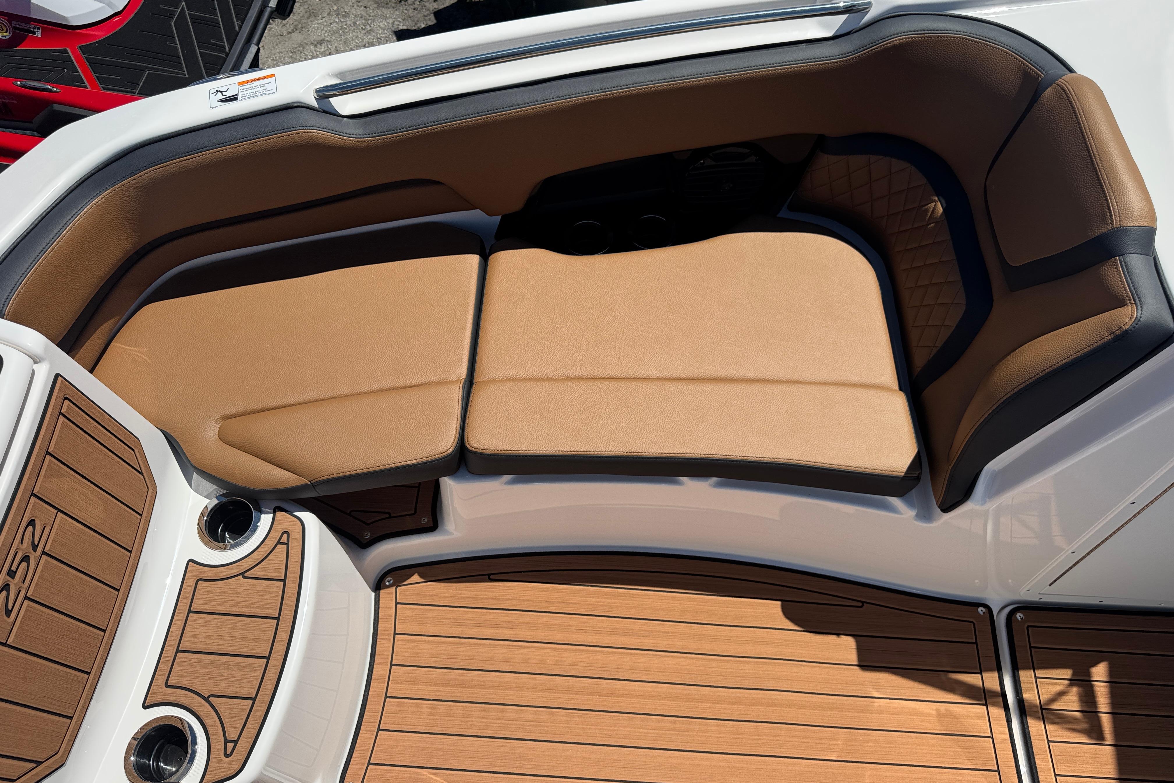 2026 Yamaha Boats 252SD interior with tan seating and wood-style flooring.