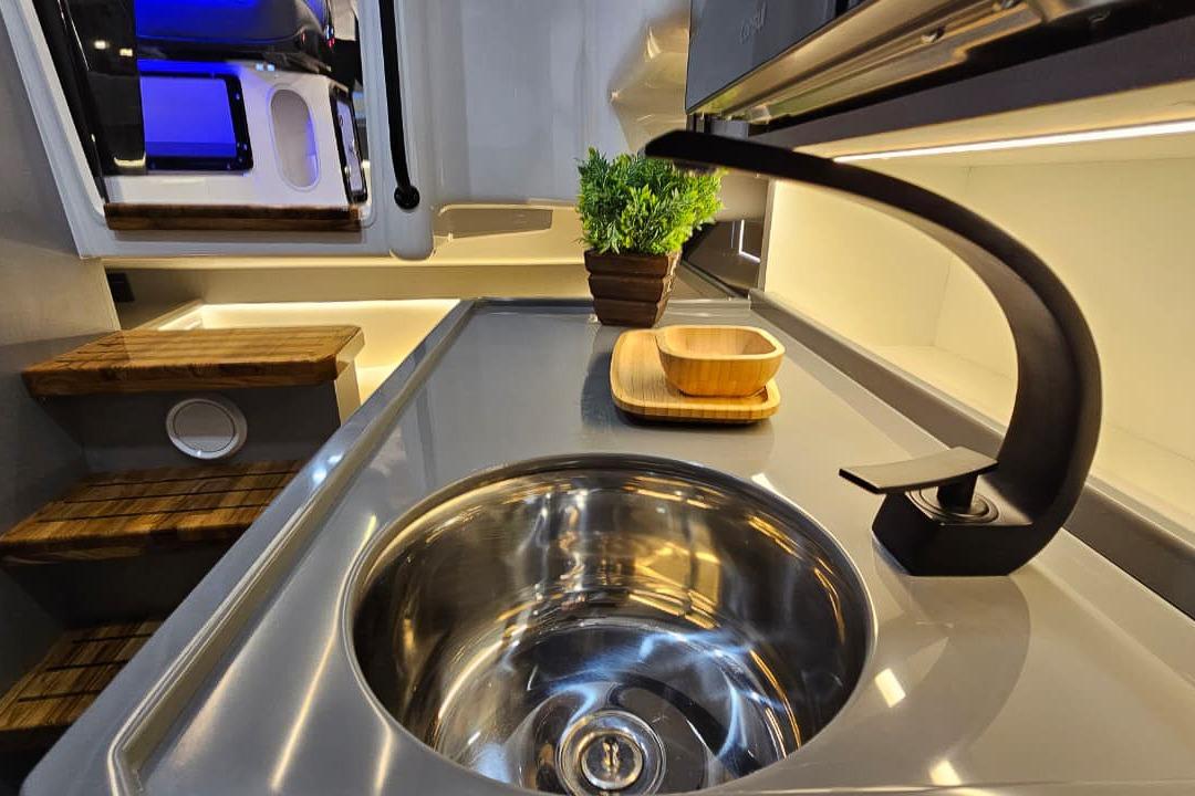 Modern kitchen interior in 2026 Hanover 327 RV with sleek sink and faucet.