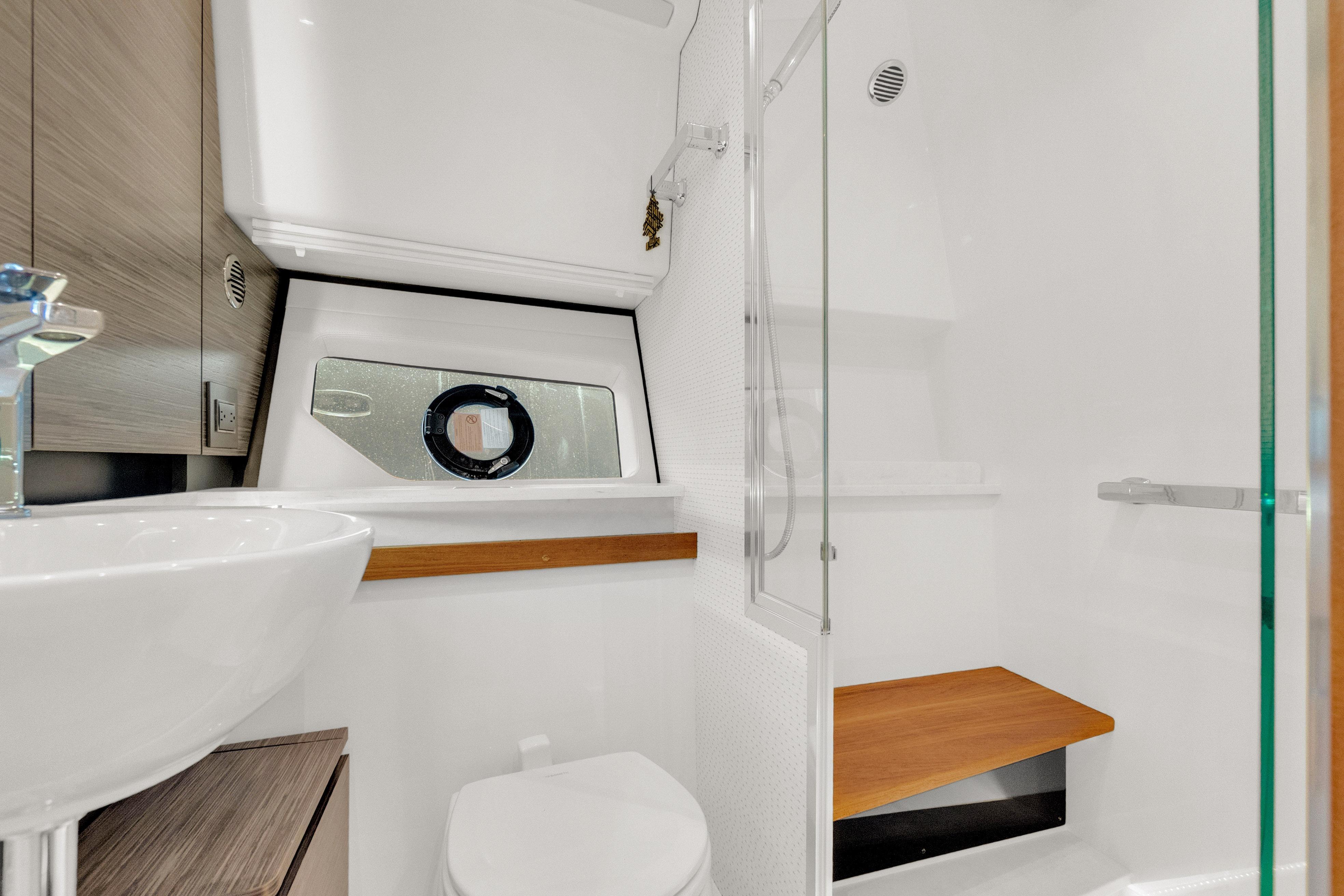 2021 Tiara Sport 43 LE yacht bathroom with modern fixtures and wooden accents.