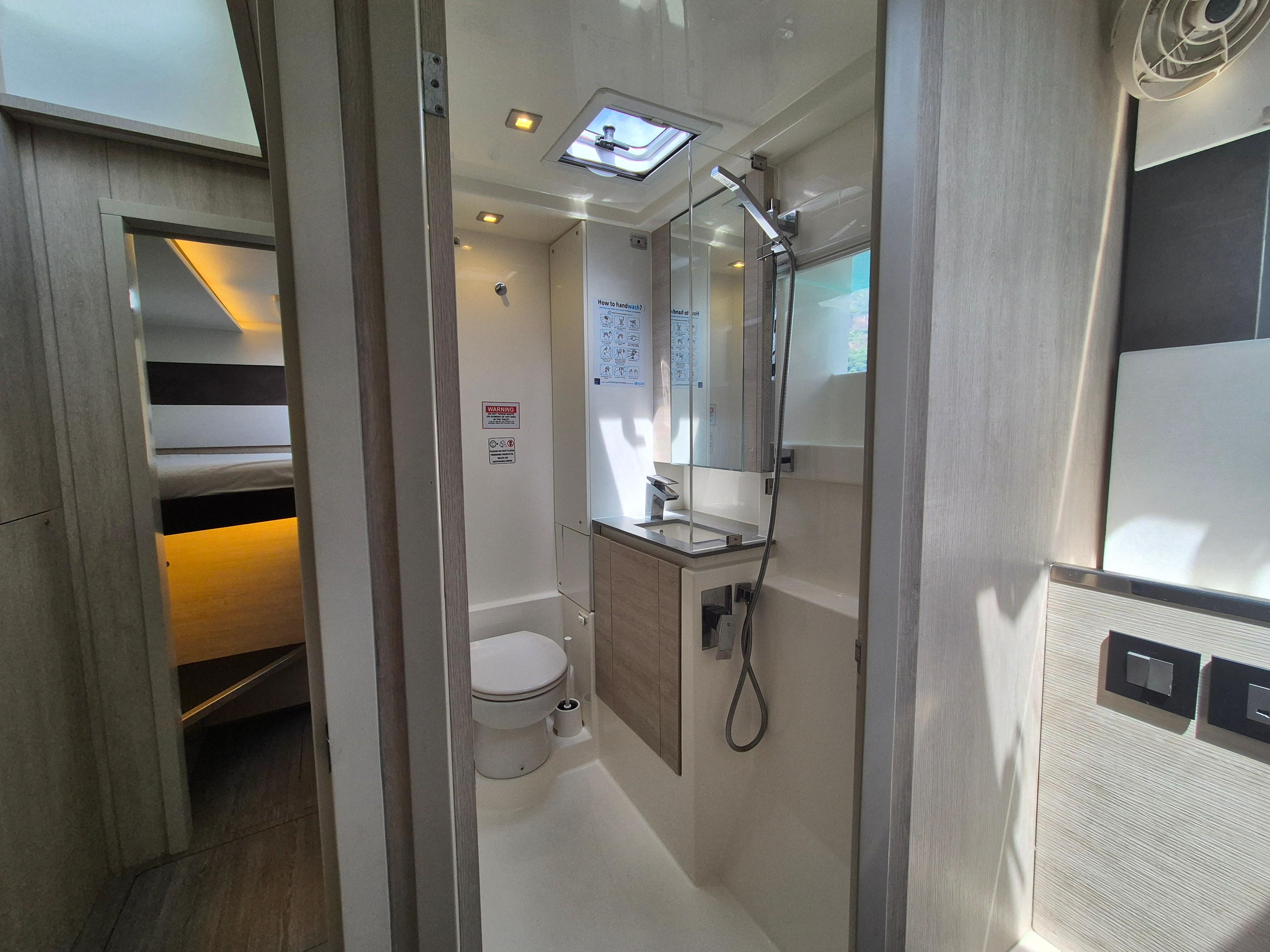 Modern bathroom in a 2020 Leopard 50 yacht, featuring sleek design and natural lighting.
