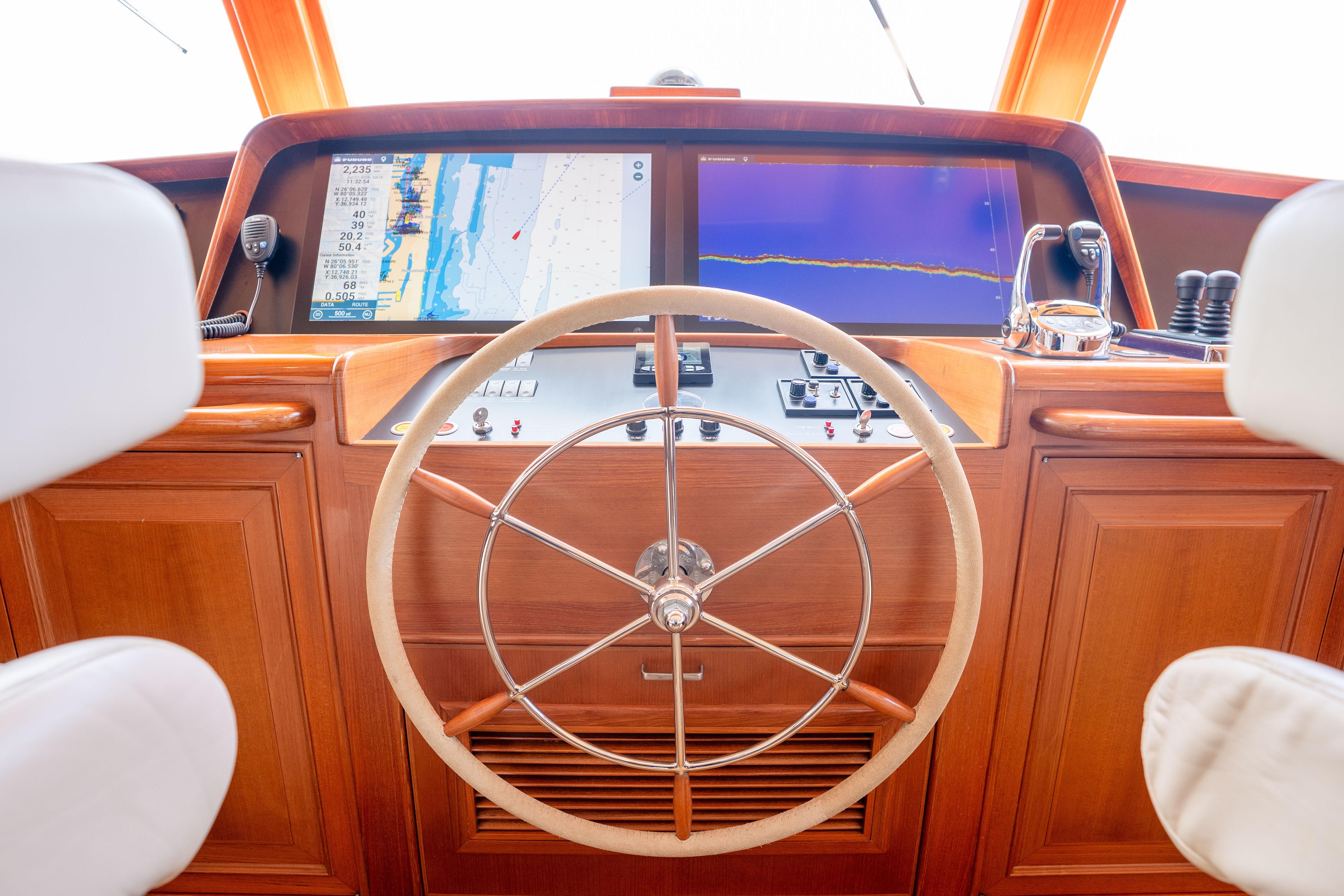 Steering wheel and navigation screens on a 2006 Fleming 75 yacht's helm.