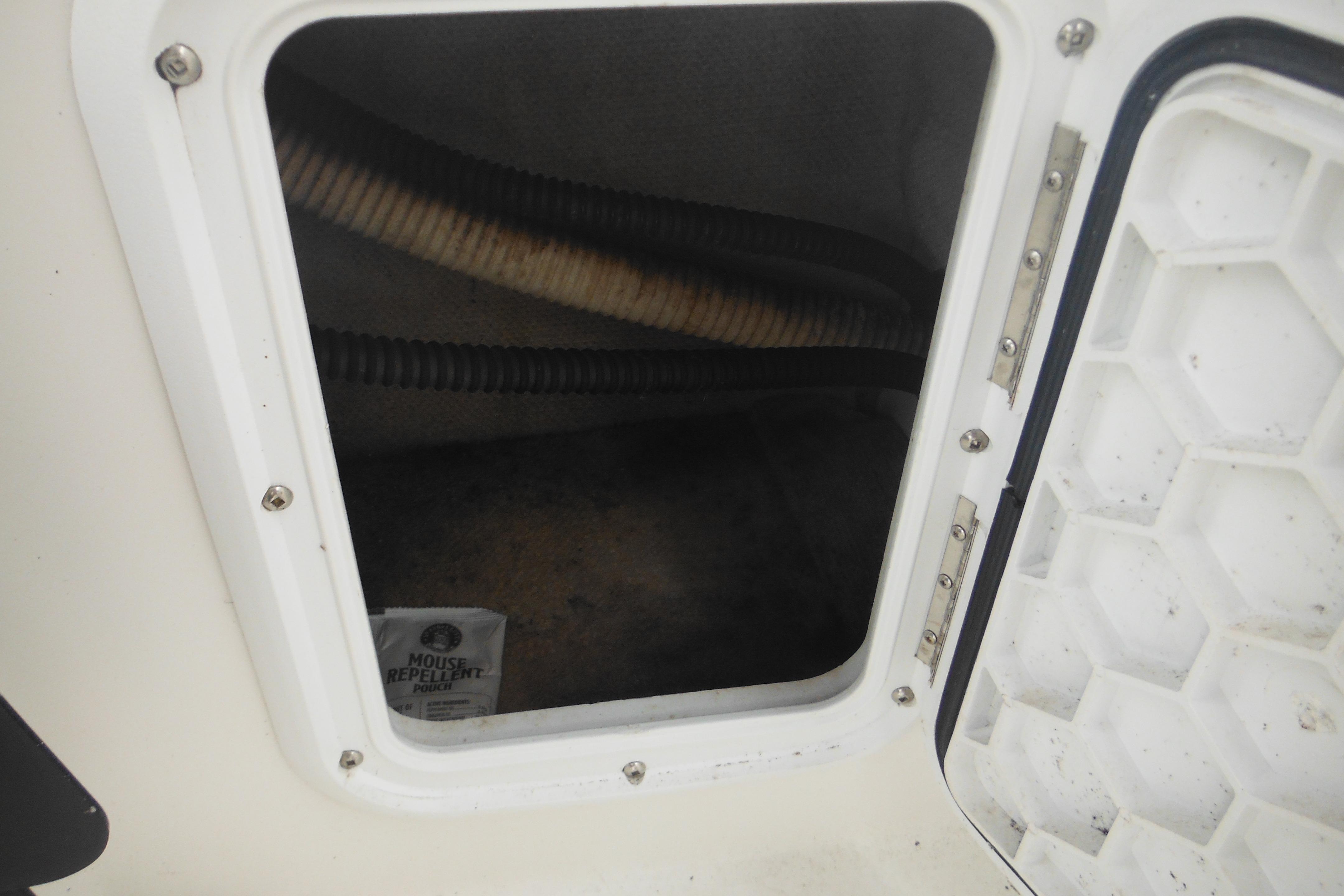 Open compartment of 2005 Seaswirl Striper 2101 Walkaround O/B with visible mouse repellent pouch.
