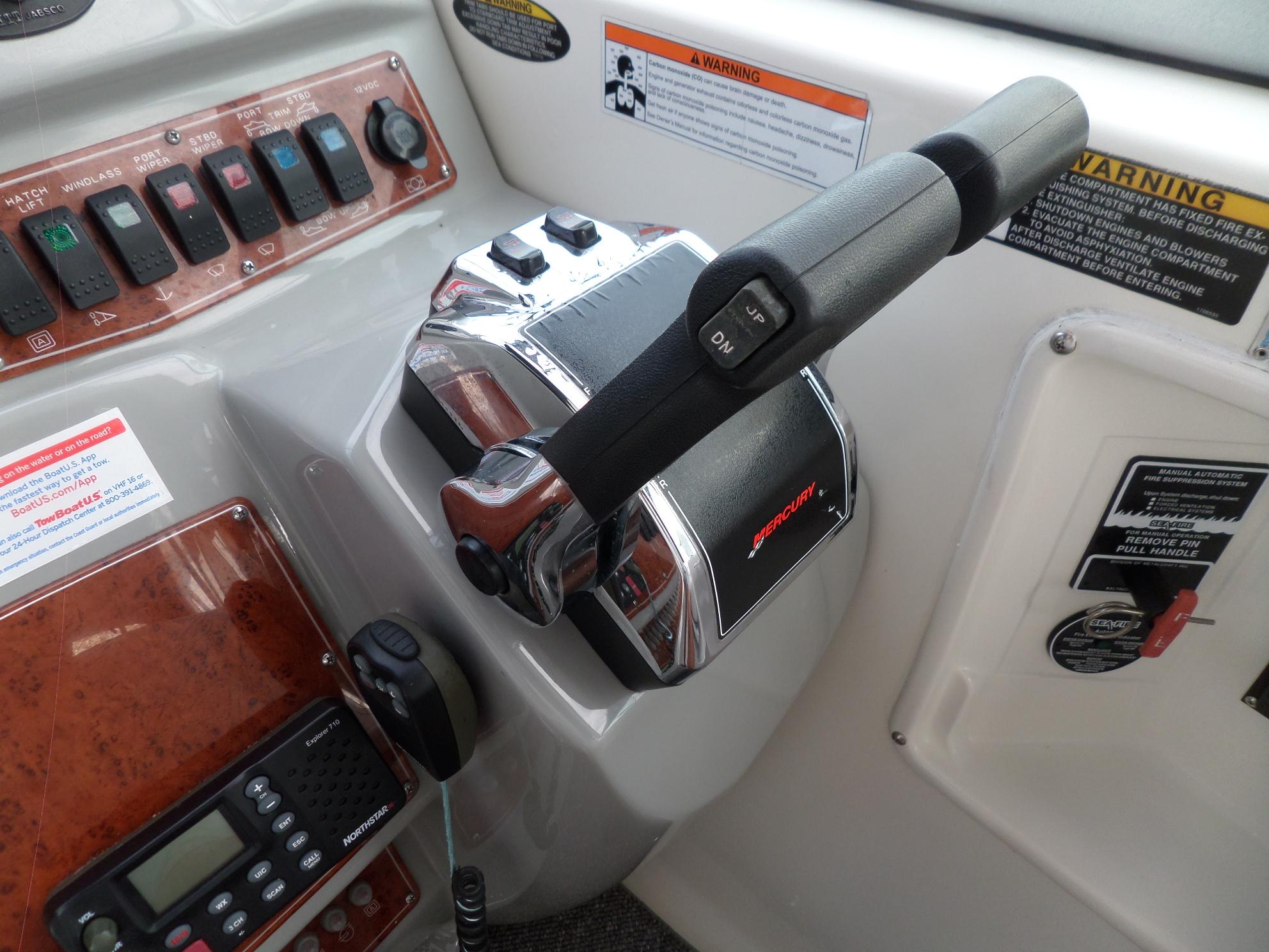 Control panel of a 2008 Bayliner 320 Express boat with throttle and switches.