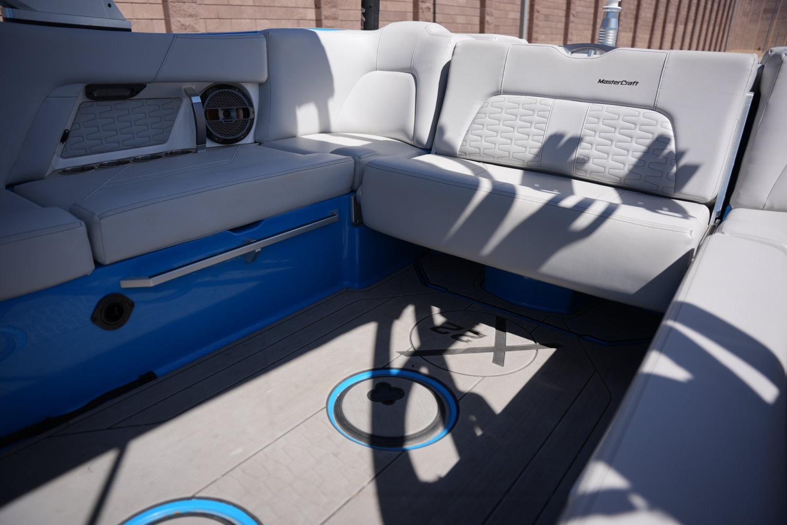 2020 MasterCraft X22 boat interior with gray seating and blue accents.