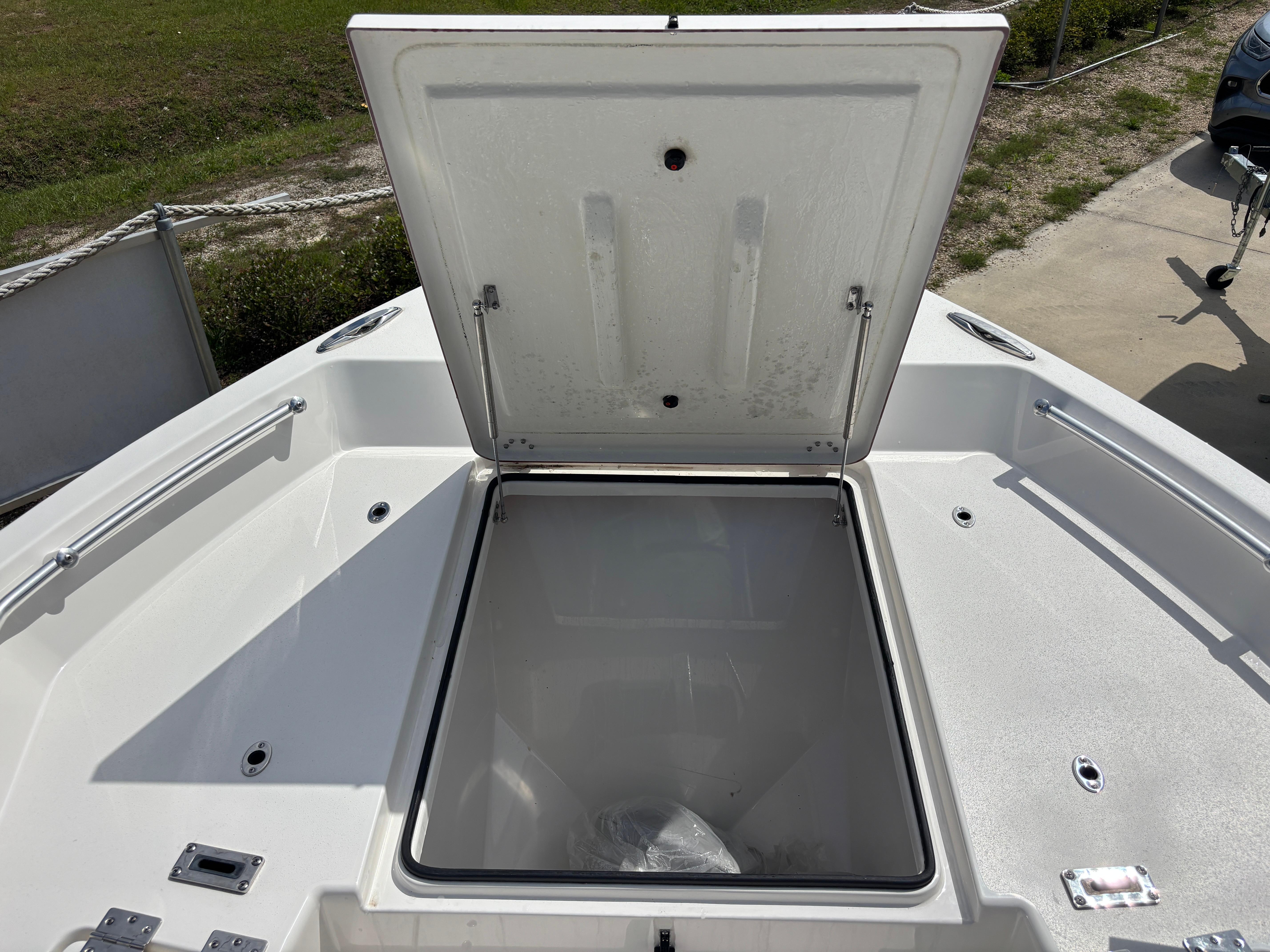 Open storage compartment on 2025 KenCraft 269 boat, showcasing spacious interior.