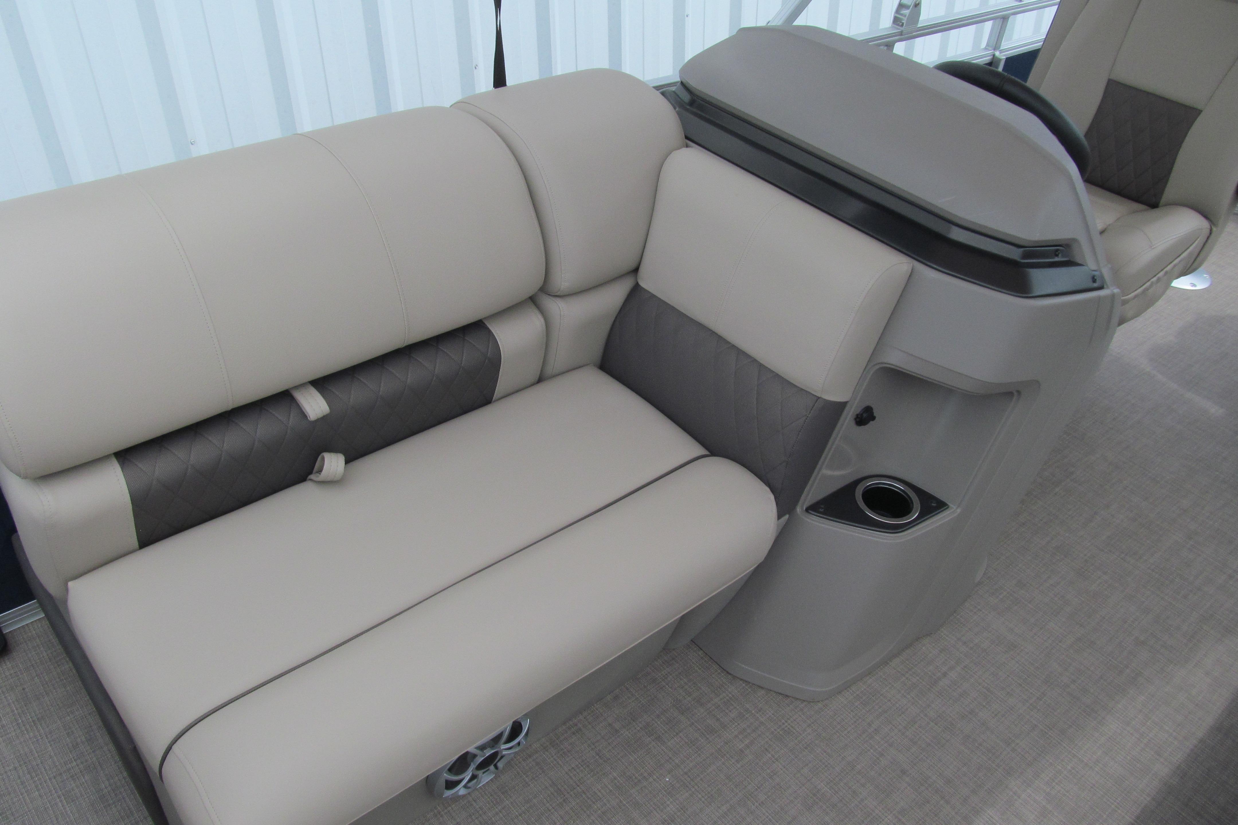 2024 Sun Tracker Fishin' Barge 20 DLX interior seating with cup holder, beige upholstery.