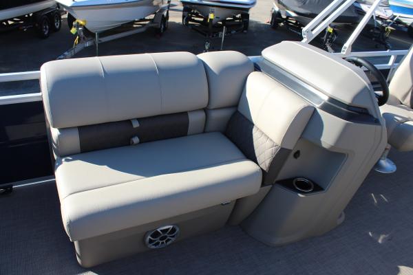 2025 Sun Tracker Fishin' Barge 22 DLX interior seating with cup holder and speaker.