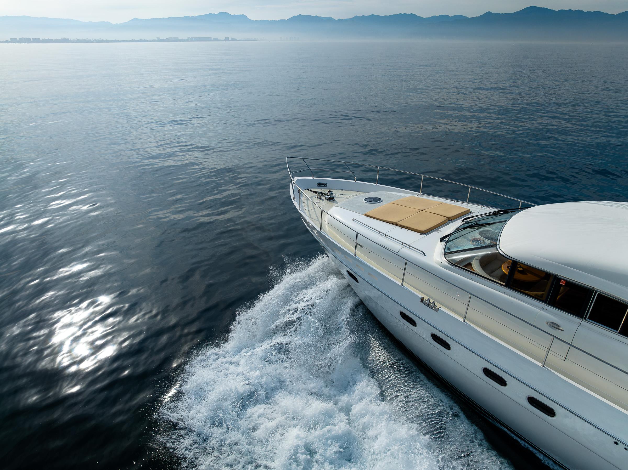 2002 Viking Princess 72 SportCruiser yacht cruising on calm ocean waters.