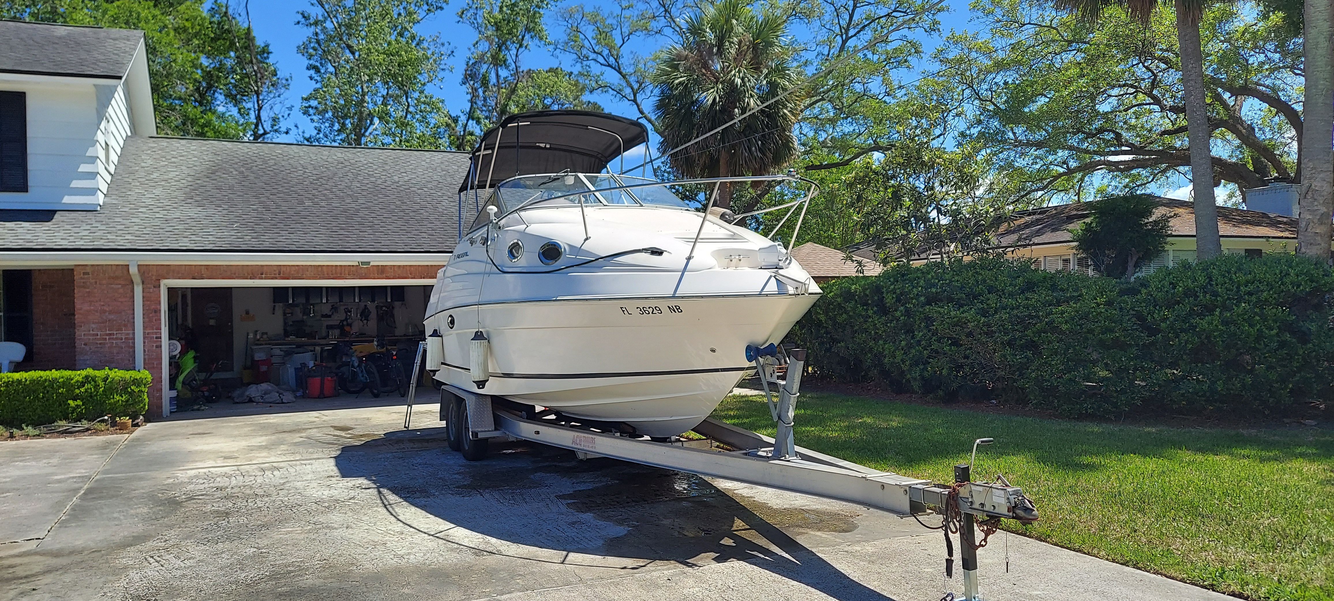 2004 Regal Commodore 2465 boat on trailer in driveway.