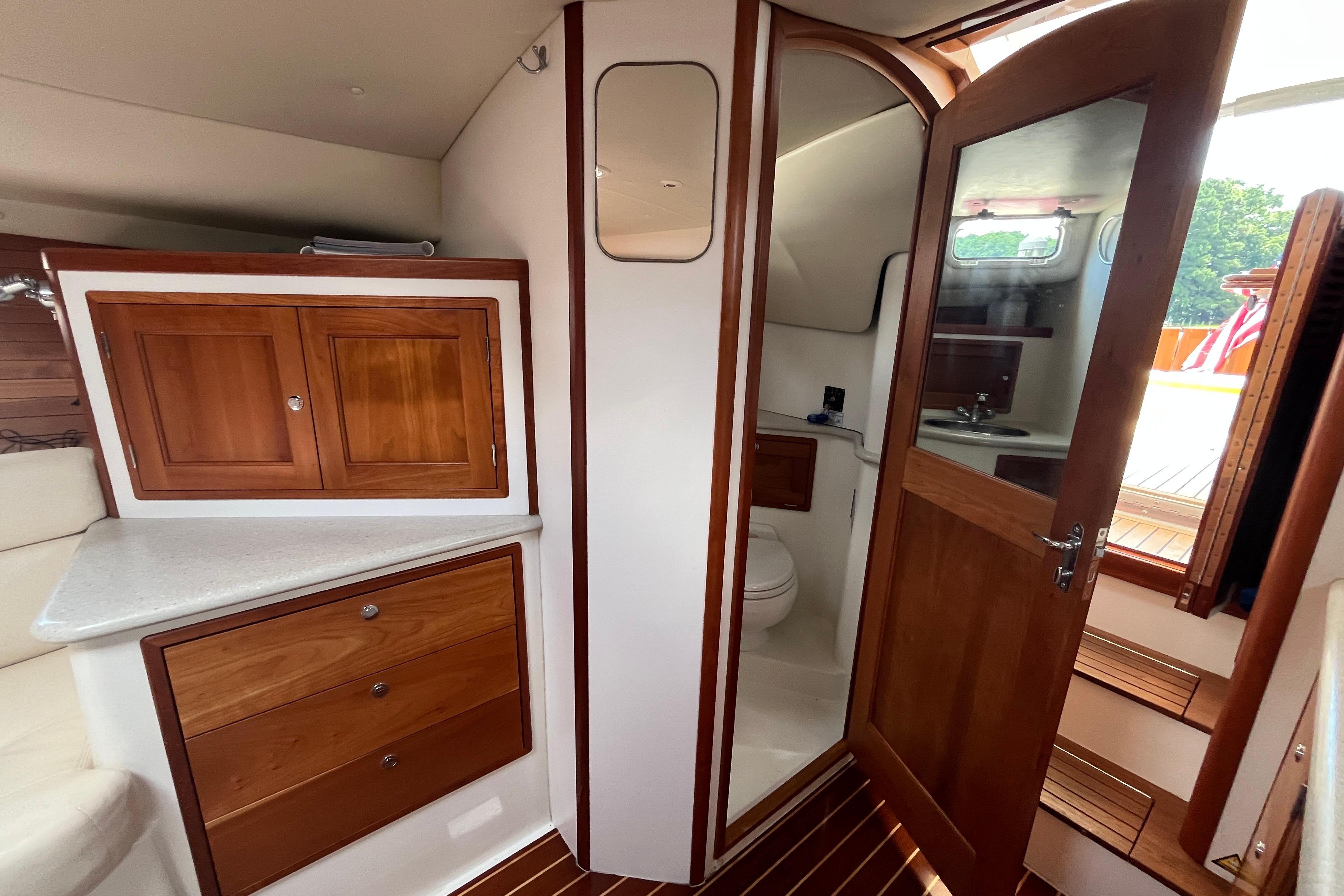 2006 MJM 34z yacht interior with wooden cabinetry and bathroom.