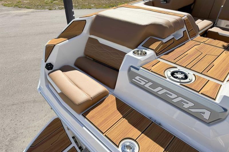 2026 Supra SL boat interior with tan seating and wood accents, showcasing luxury design.