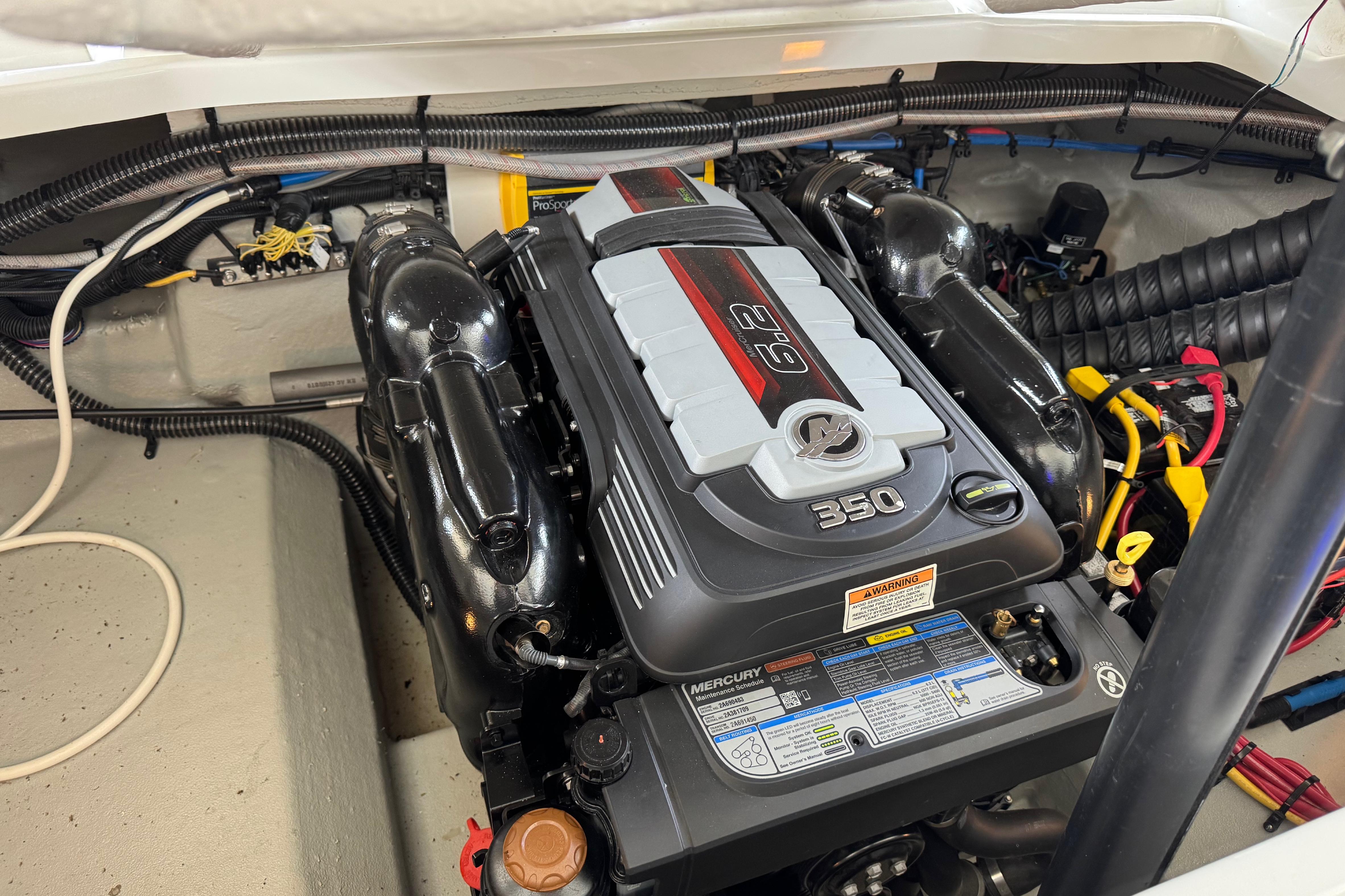 Engine compartment of 2022 Crownline 265 SS boat featuring a Mercury 350 engine.