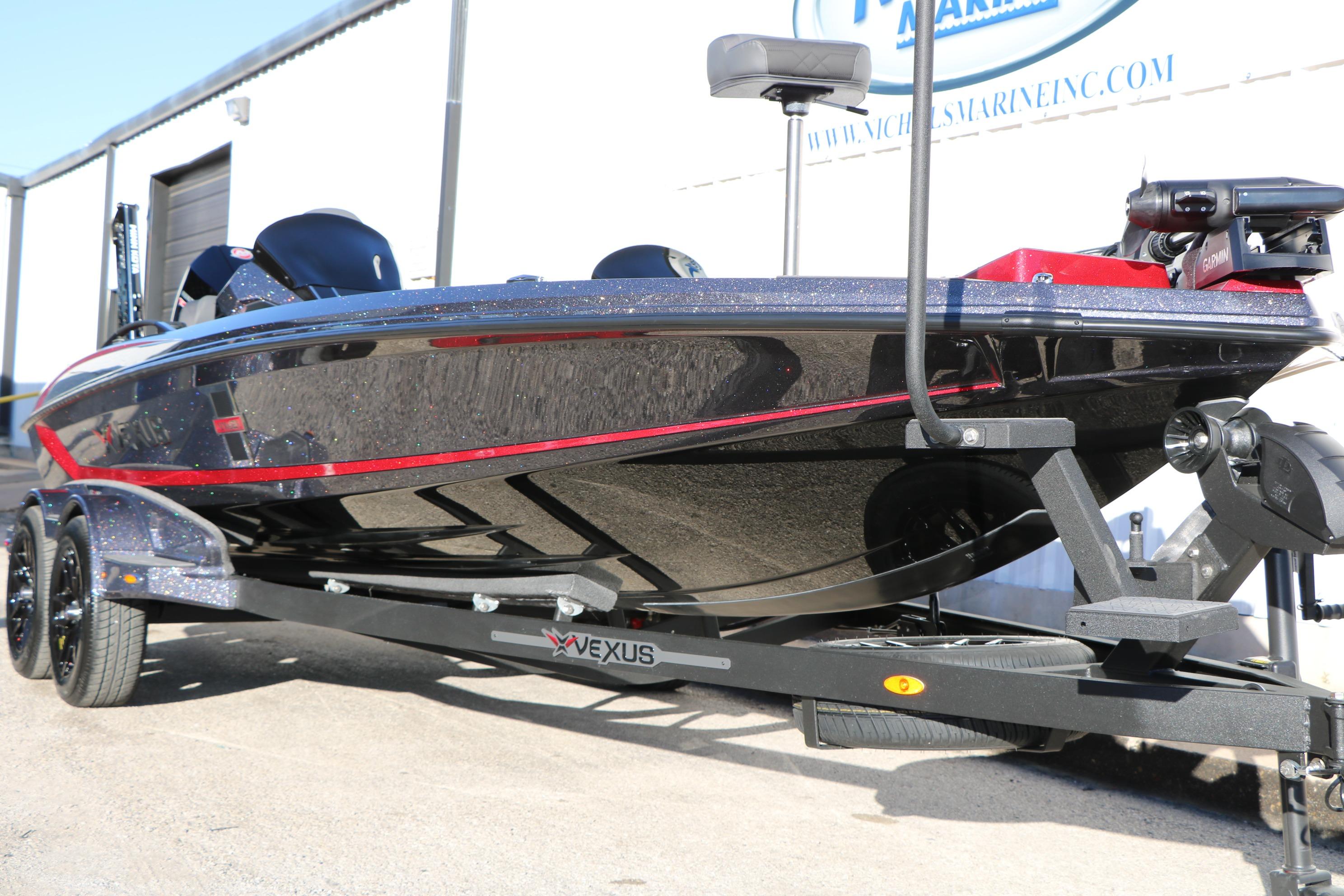 2026 Vexus VXs21 boat on trailer, sleek design with red accents.