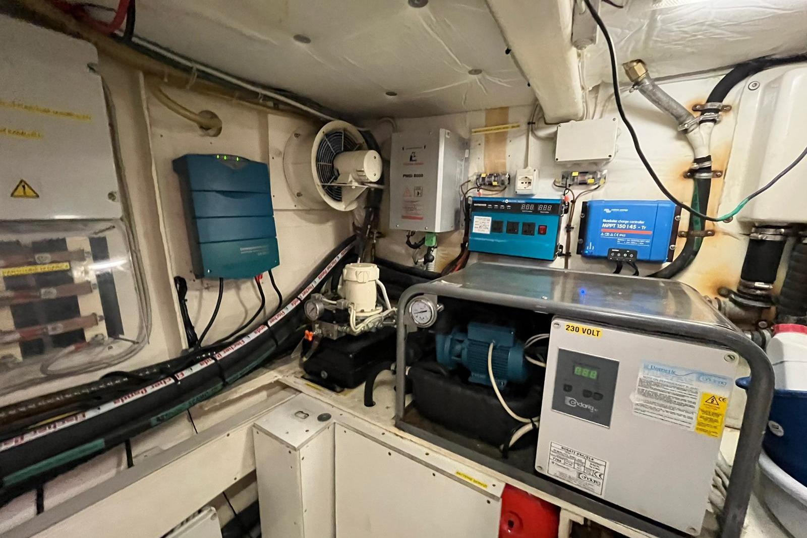 Engine room of 2009 Queens Yachts QUEENS 54, showcasing electrical systems and equipment.