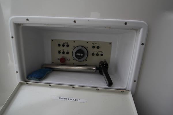 A control panel with buttons and a gauge inside a white compartment.
