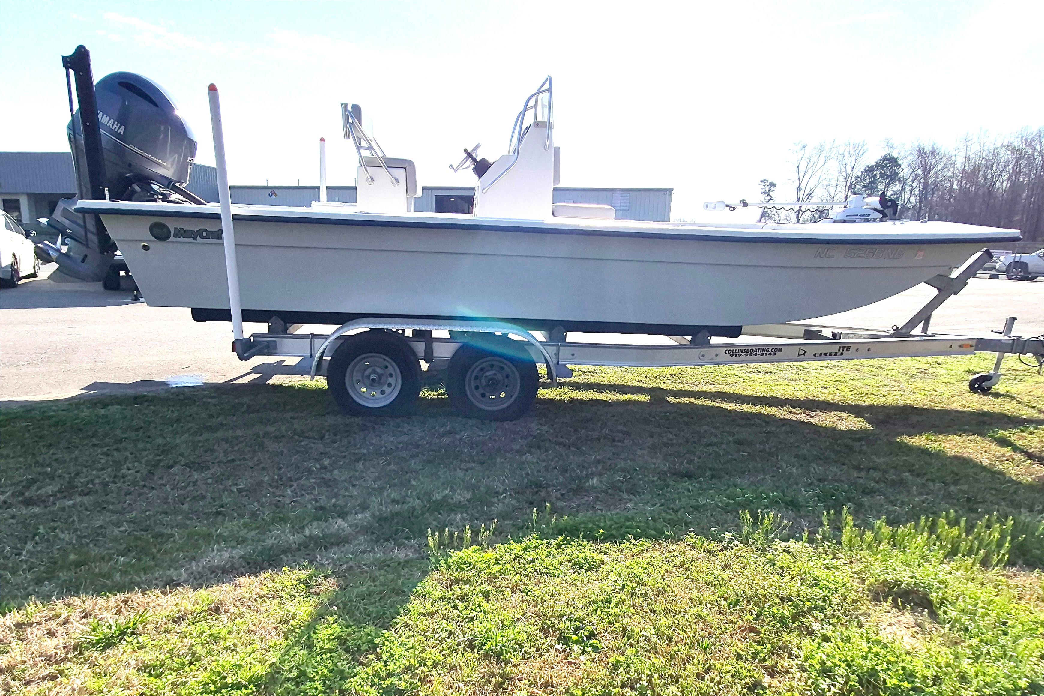 2024 May-Craft 22 Hancock Skiff on trailer, parked outdoors in a sunny setting.