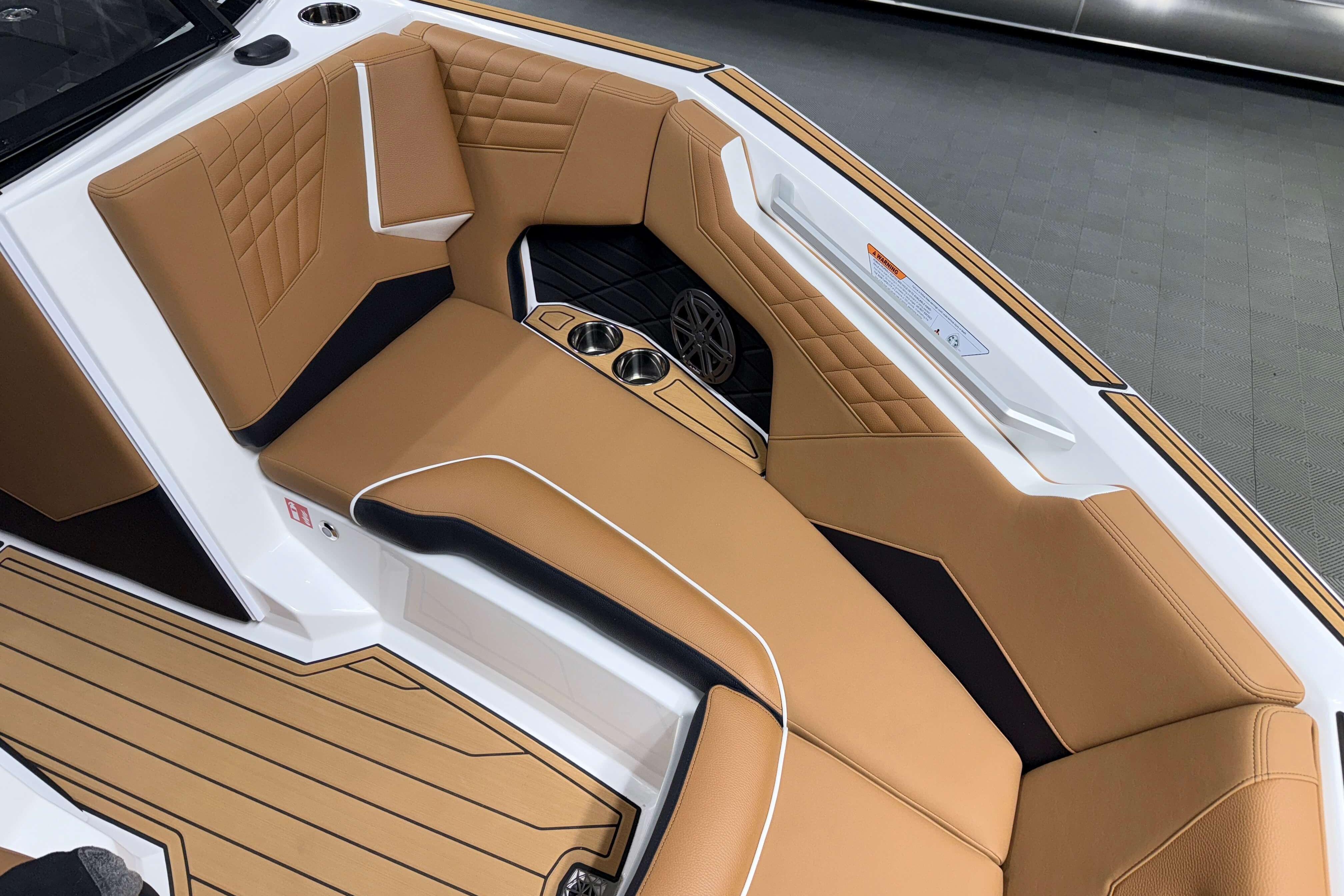 Luxurious interior of 2026 Nautique Super Air Nautique S23 boat with tan seating.