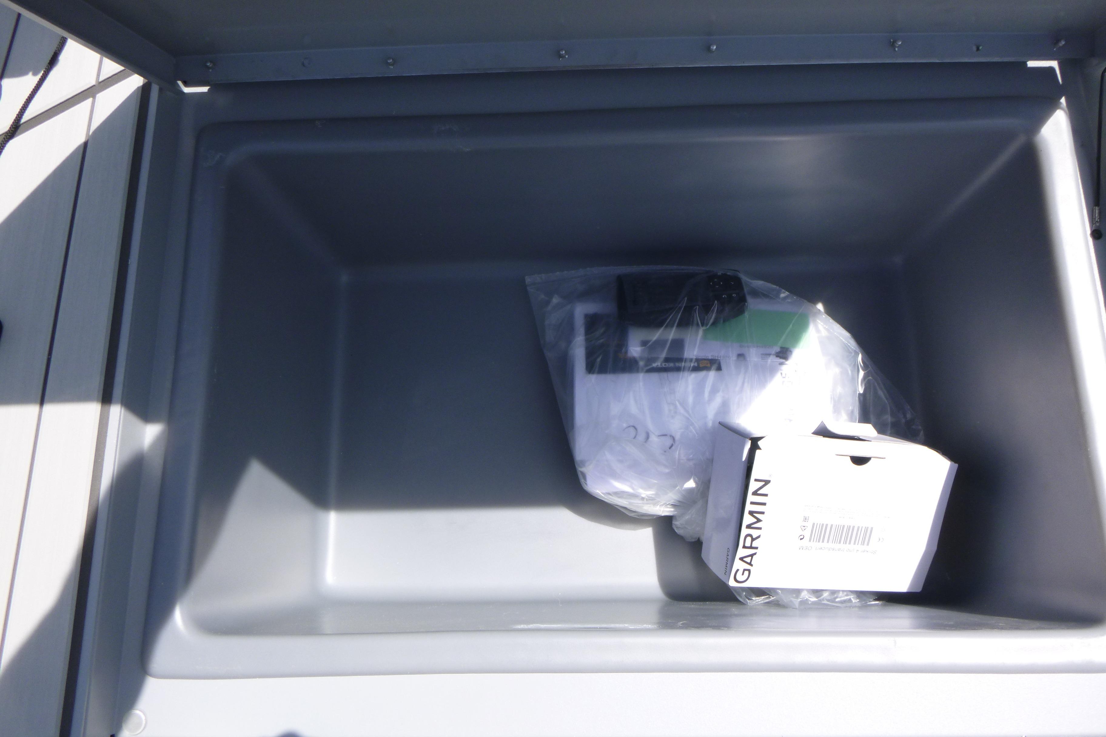 Storage compartment of 2026 Tracker Bass Tracker Classic CC with Garmin box inside.