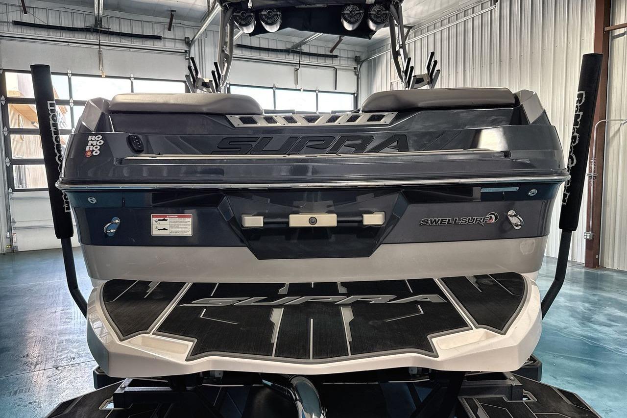 2021 Supra SE 550 boat rear view in a garage setting.