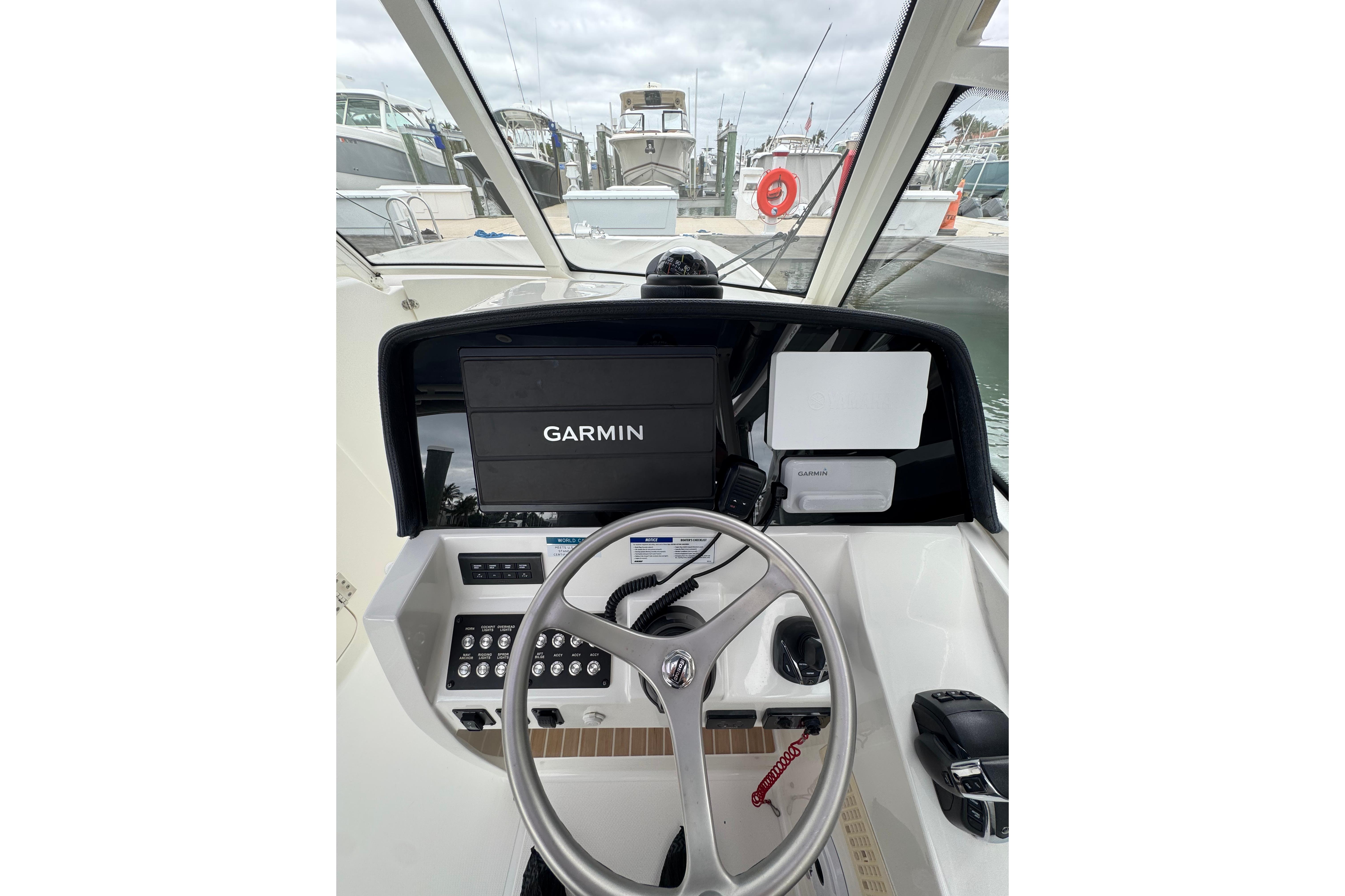 Cockpit view of 2022 World Cat 325 DC with Garmin navigation system.