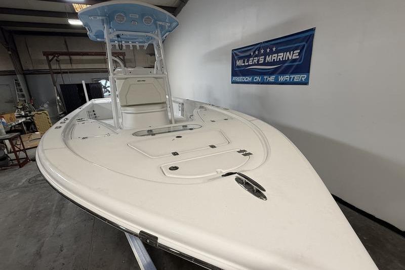2026 Sea Pro 250 Bay boat displayed indoors at Miller's Marine showroom.