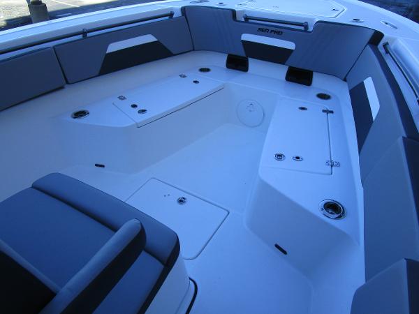 2025 Sea Pro 292 Offshore boat interior with seating and storage compartments.
