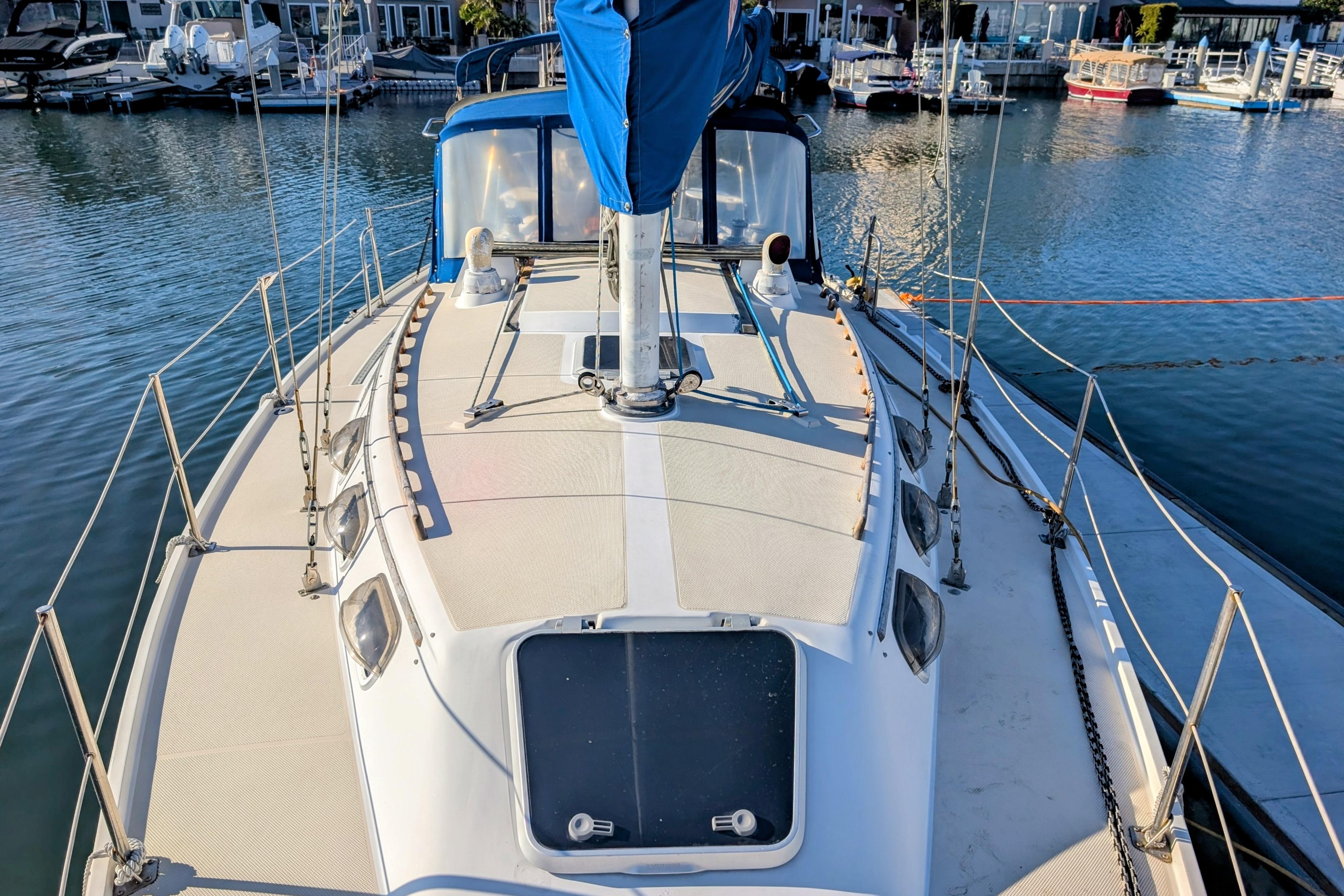 1989 Catalina 34 sailboat docked in a marina, showcasing deck and rigging.