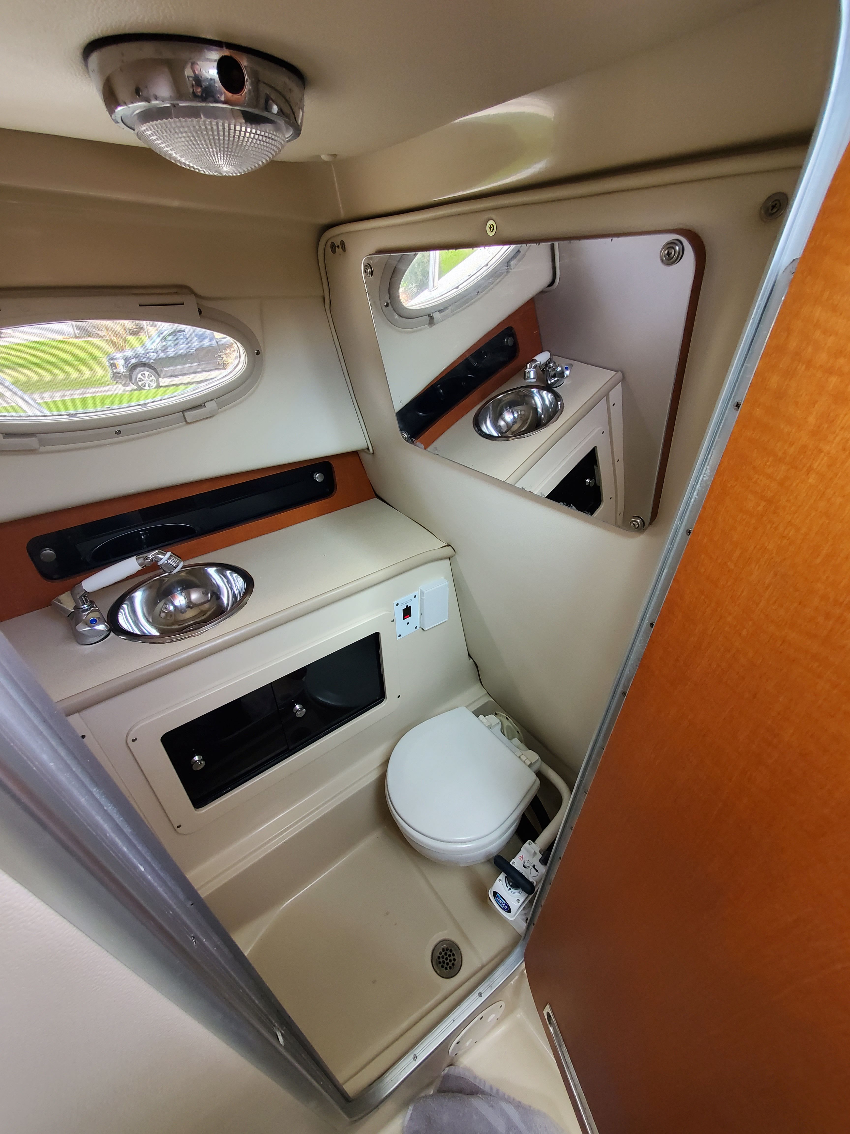 Interior of 2005 Robalo R265 Walkaround with toilet and sink.