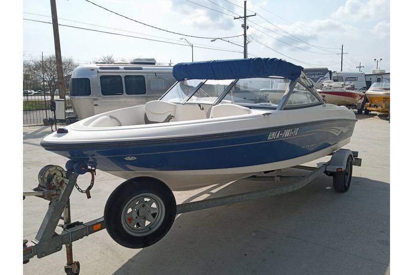 2008 Bayliner 175 boat on trailer with blue canopy in outdoor setting.