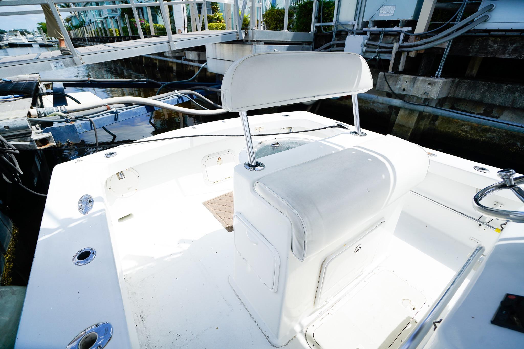1977 Scarborough 27 CC boat interior with white seating and dockside view.