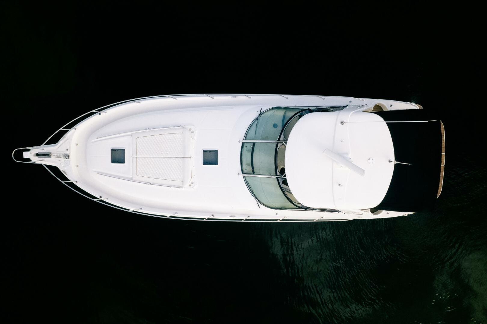 Aerial view of 2003 Sea Ray Sundancer 460 yacht on dark water.