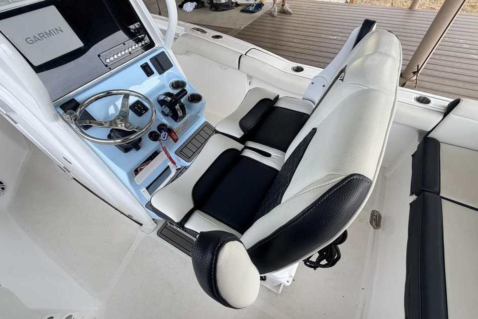 2024 Tidewater 232 LXF boat cockpit with Garmin navigation and plush seating.