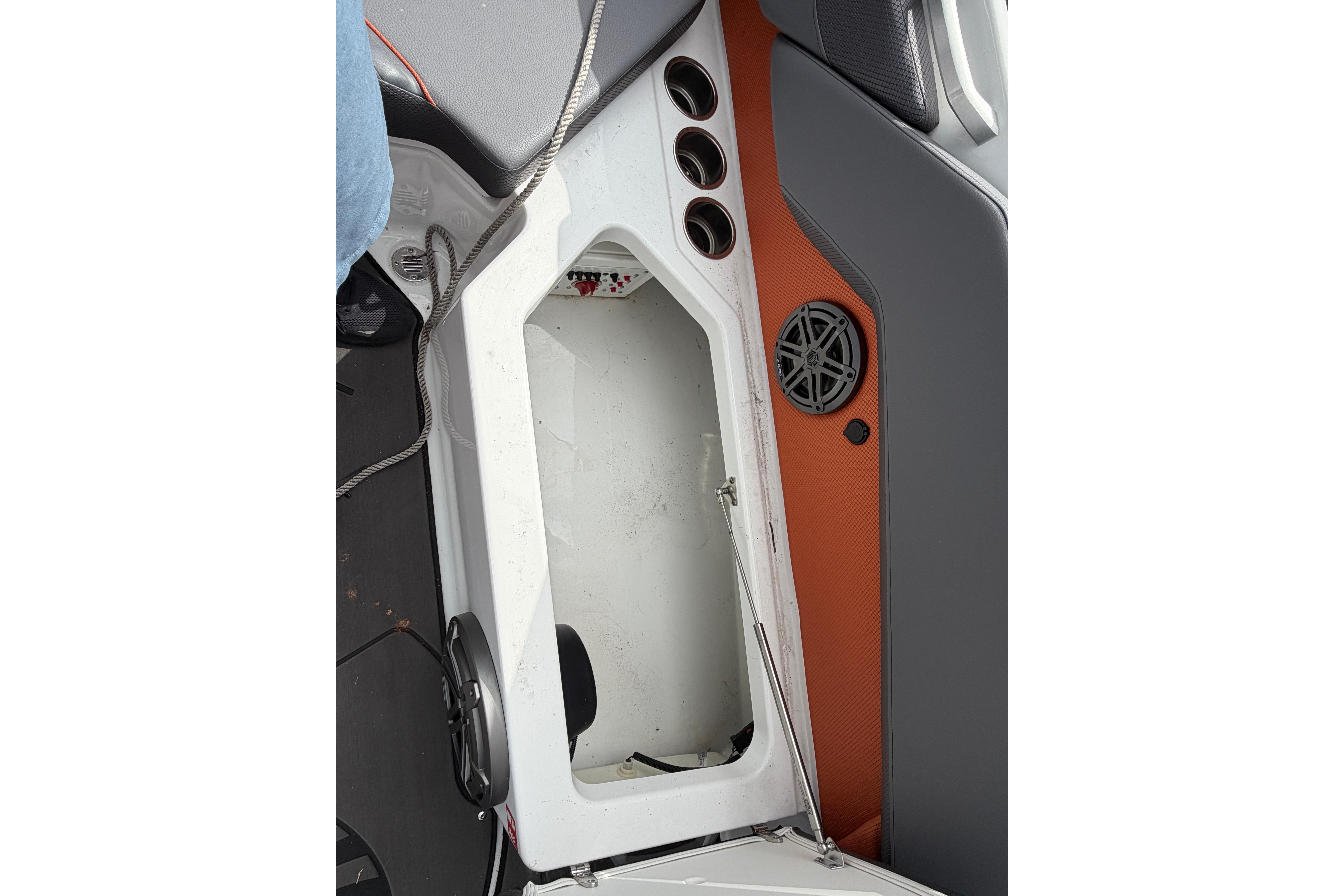 Interior view of 2026 Scarab 235 LX boat showing storage compartment and speaker.