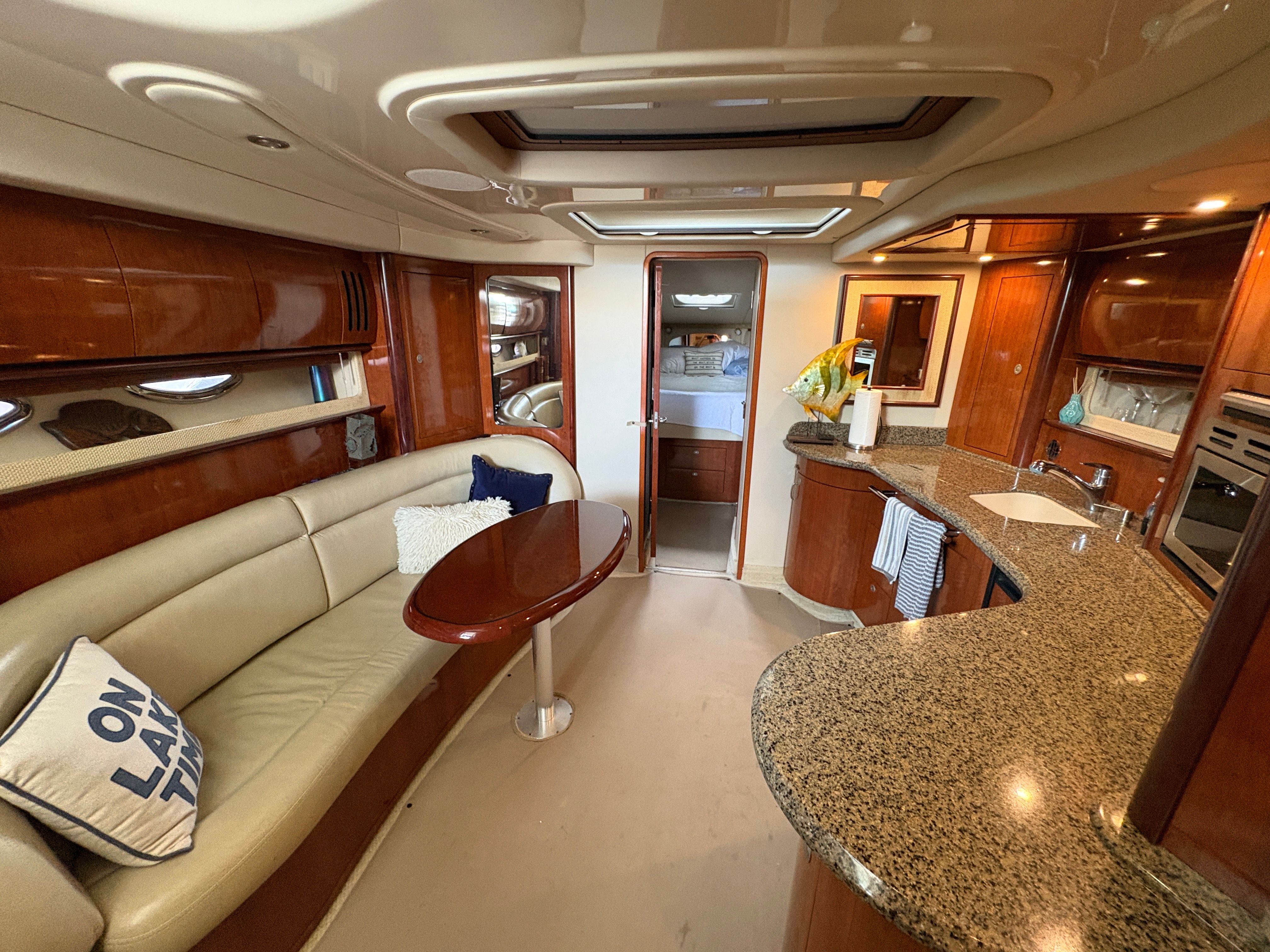 Interior of a 2005 Sea Ray 420 Sundancer yacht with kitchen and lounge.