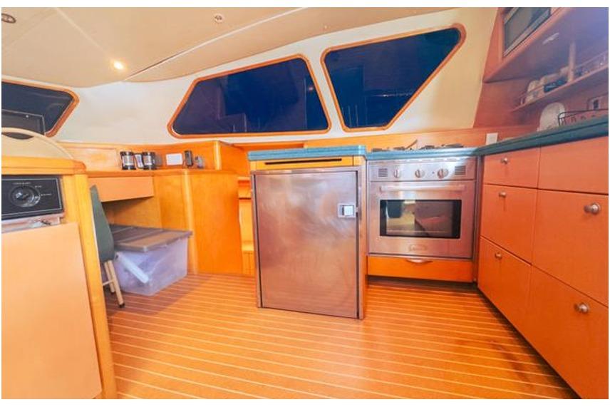 Luxurious yacht kitchen interior with modern appliances, wooden cabinetry, and sleek design, 2005 model.
