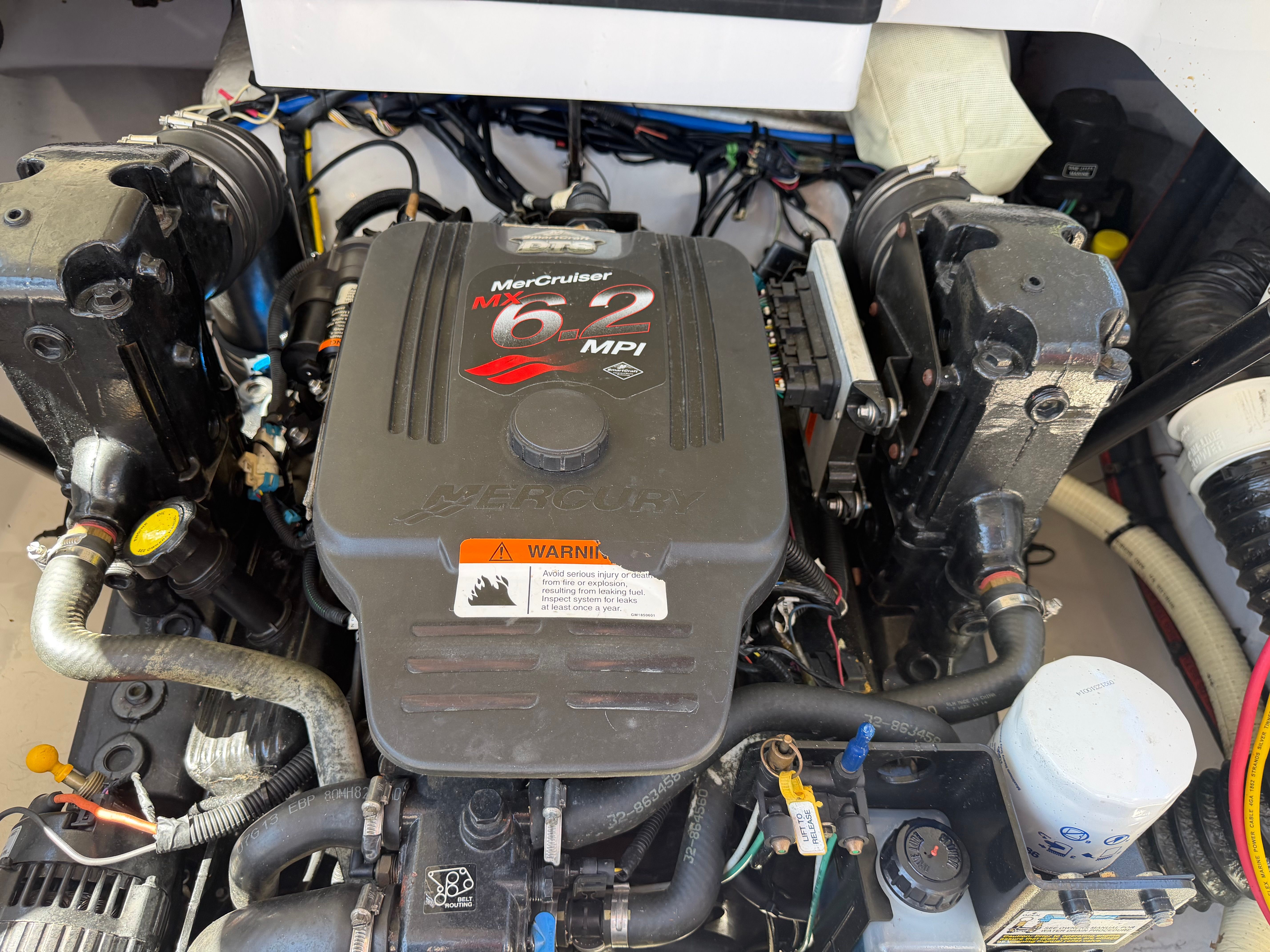 Engine compartment of a boat featuring a MerCruiser 6.2 MPI engine.