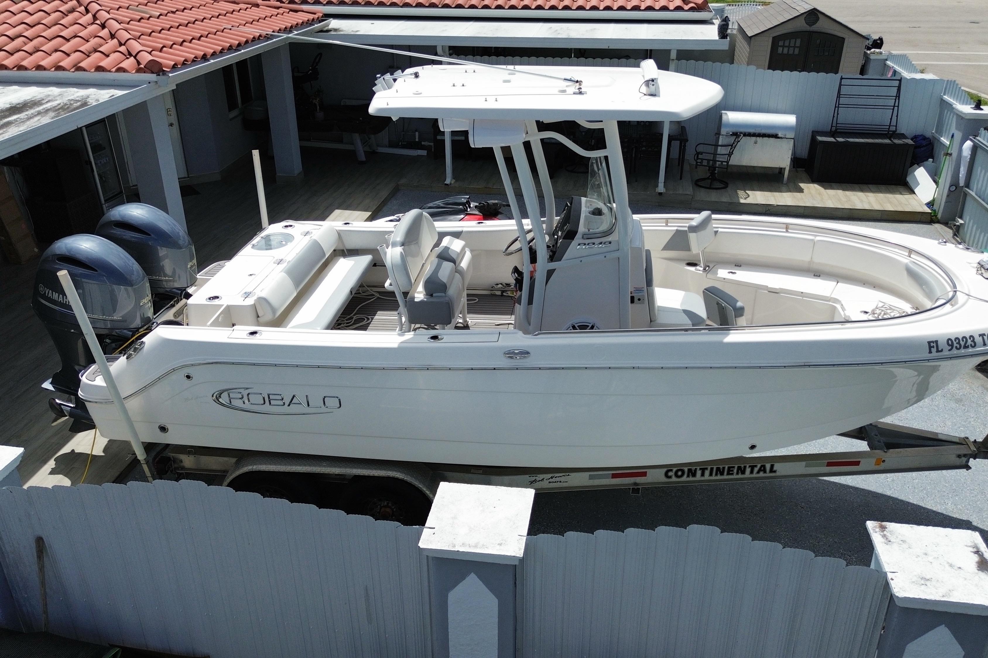 2022 Robalo R242 Center Console boat with twin Yamaha engines on a trailer.