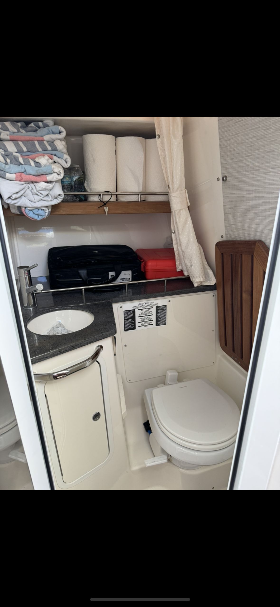 Interior of 2020 Boston Whaler 350 Realm featuring bathroom and storage.
