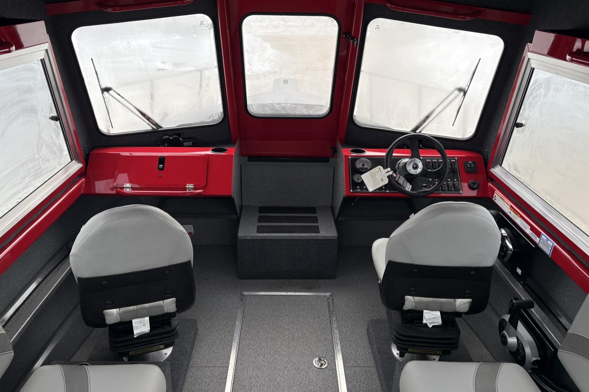 Interior of 2024 Spartan 240 Maximus Pro boat with dual seats and steering console.