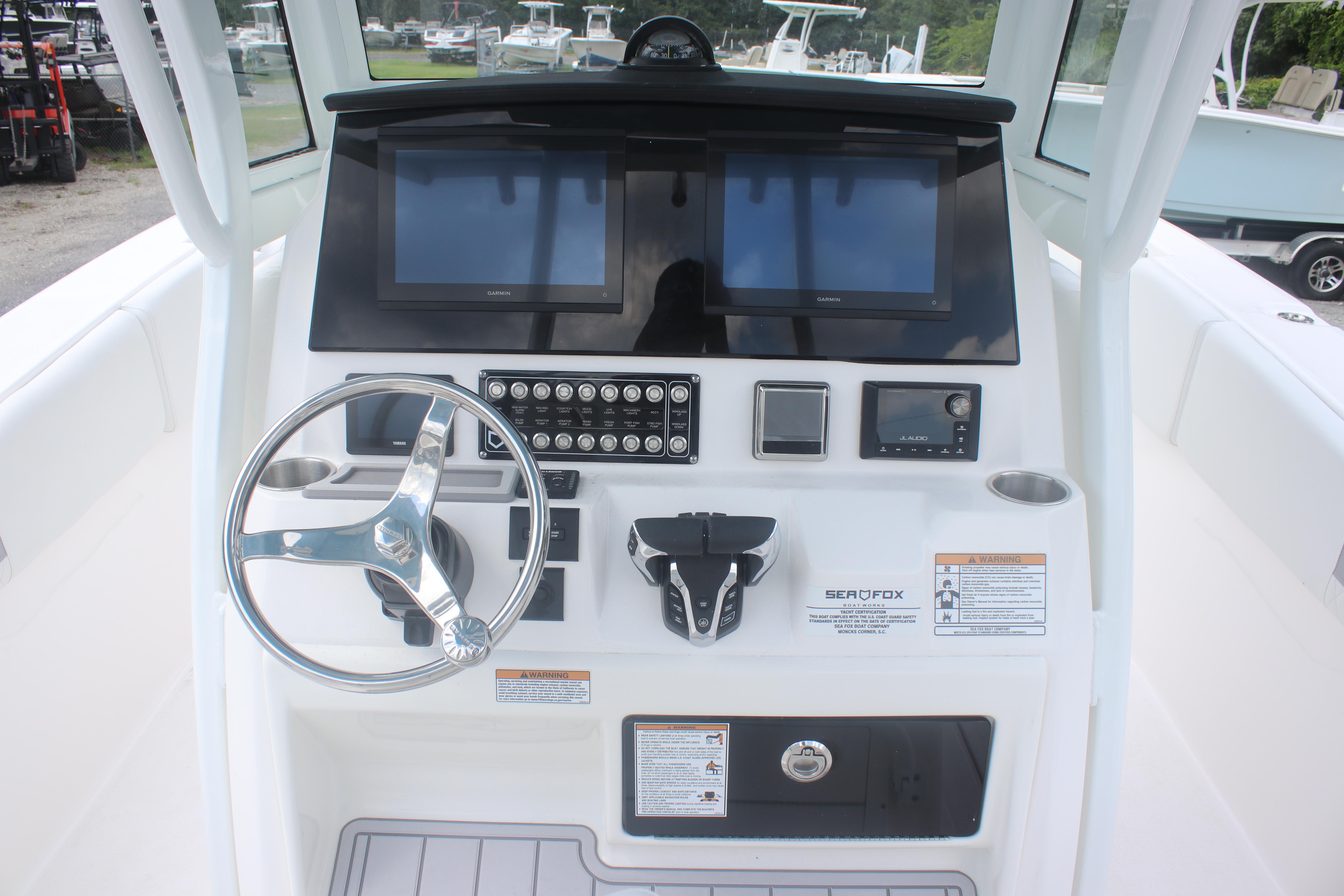 2026 Sea Fox 288 Commander boat dashboard with steering wheel and electronic controls.