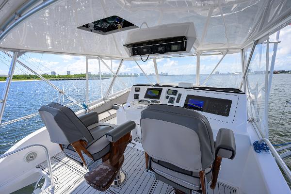 Helm of 2000 Viking 50 Convertible yacht with dual seats and navigation equipment.