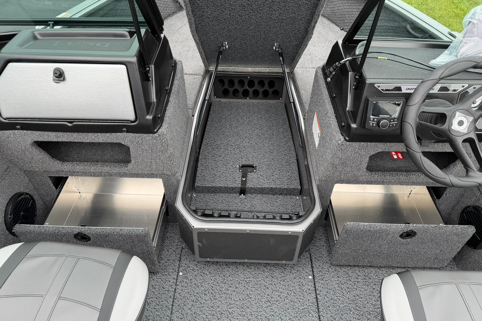Interior view of 2027 Lund 1875 Impact XS Sport boat, showcasing storage compartments and steering console.