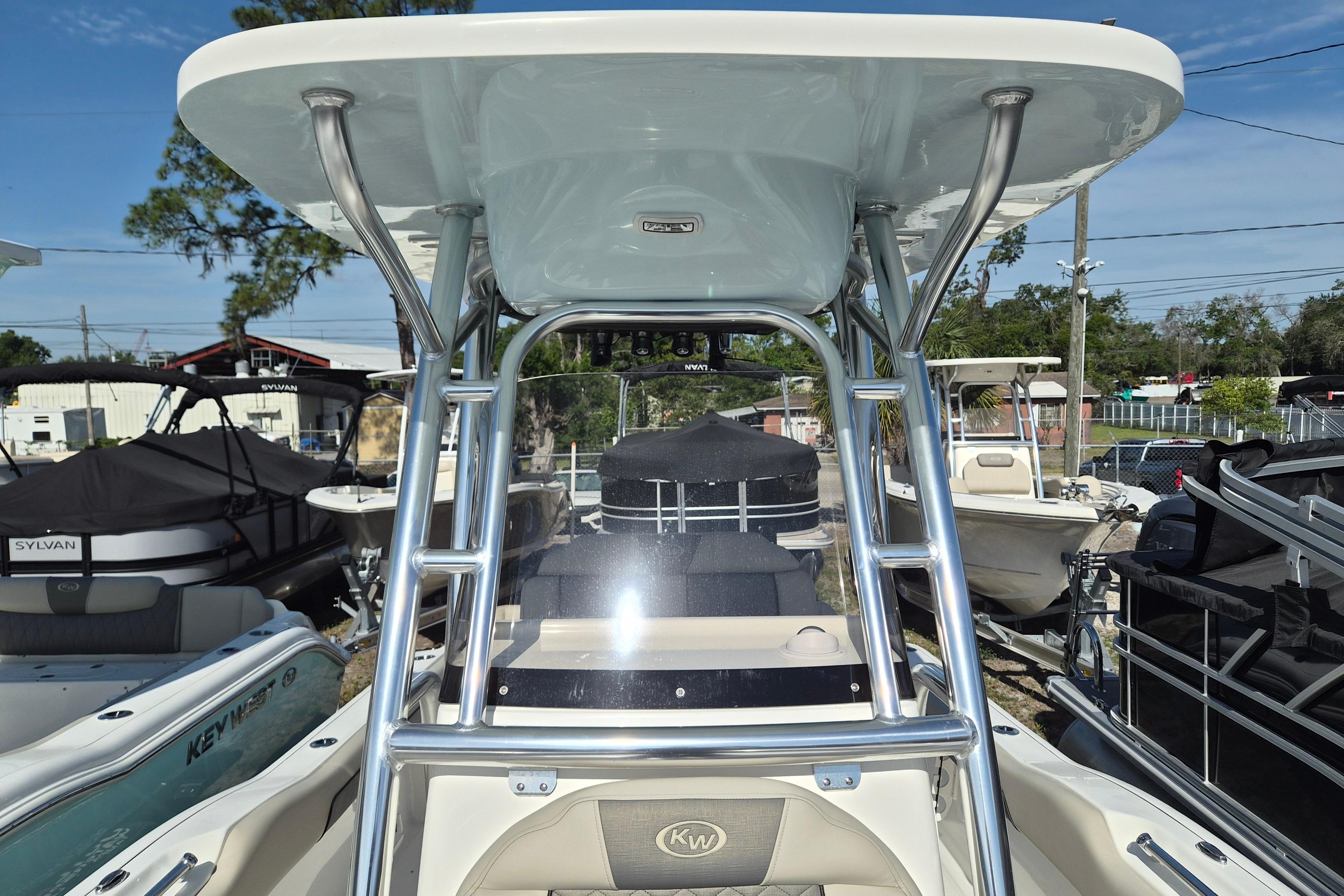 2026 Key West 239 FS boat with T-top and sleek design in a marina setting.