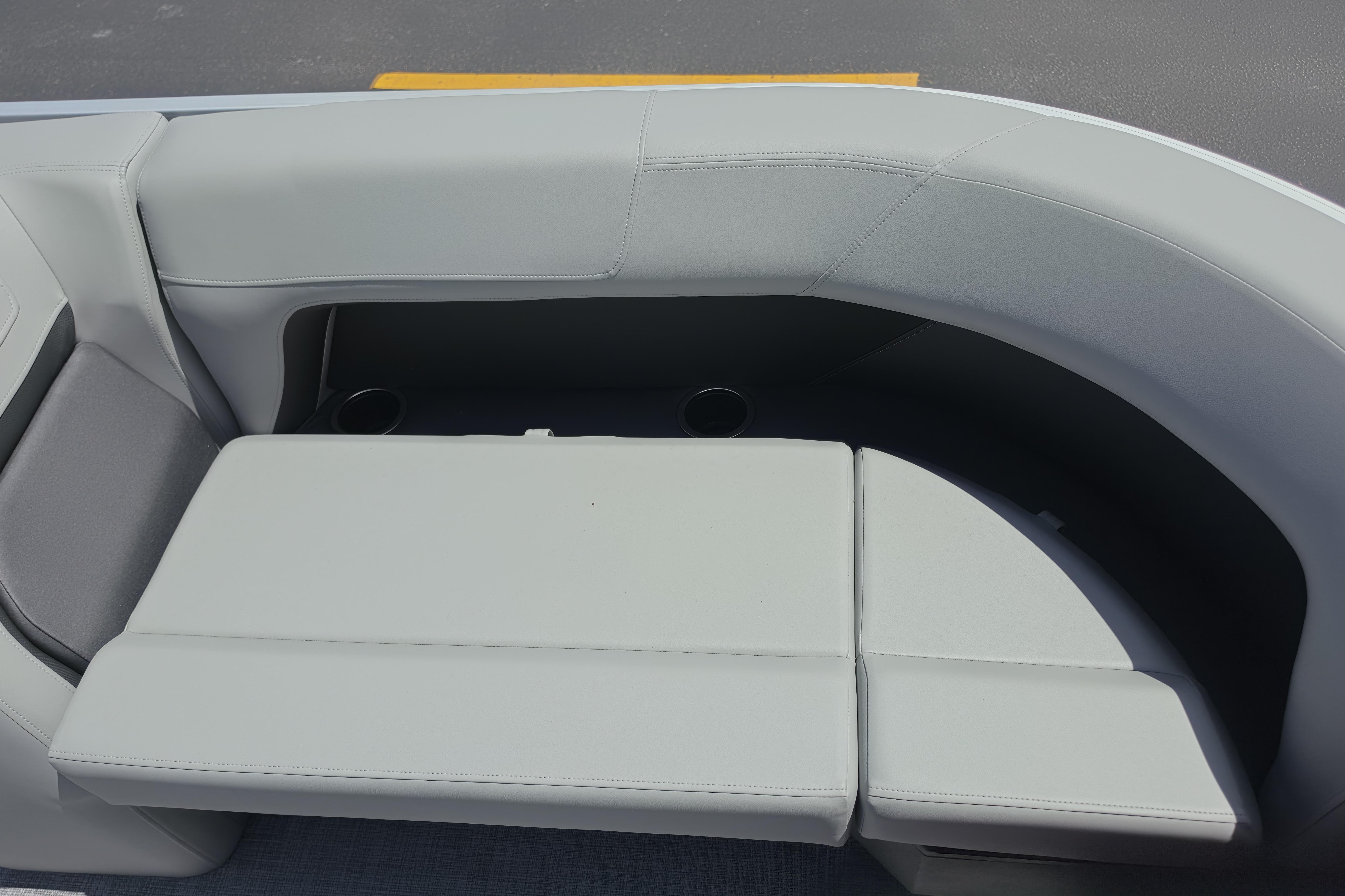 2026 Sun Tracker Party Barge 18 DLX boat seating with cup holders, gray upholstery.