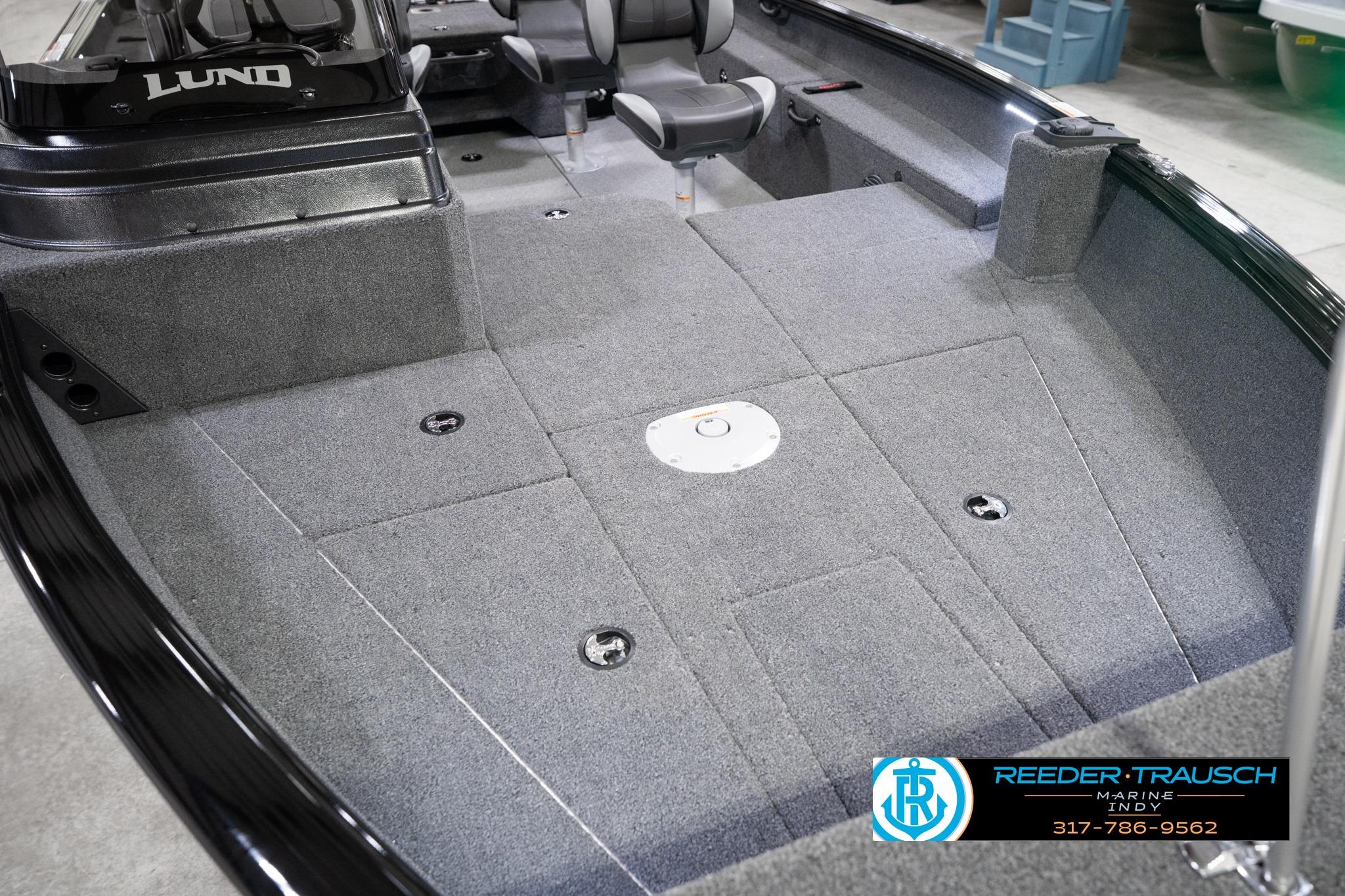 2026 Lund 1775 Impact XS SS boat interior with gray carpet and seating.