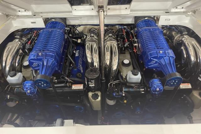 Twin blue engines in a 2007 Formula 382 FASTech boat, showcasing high-performance power.