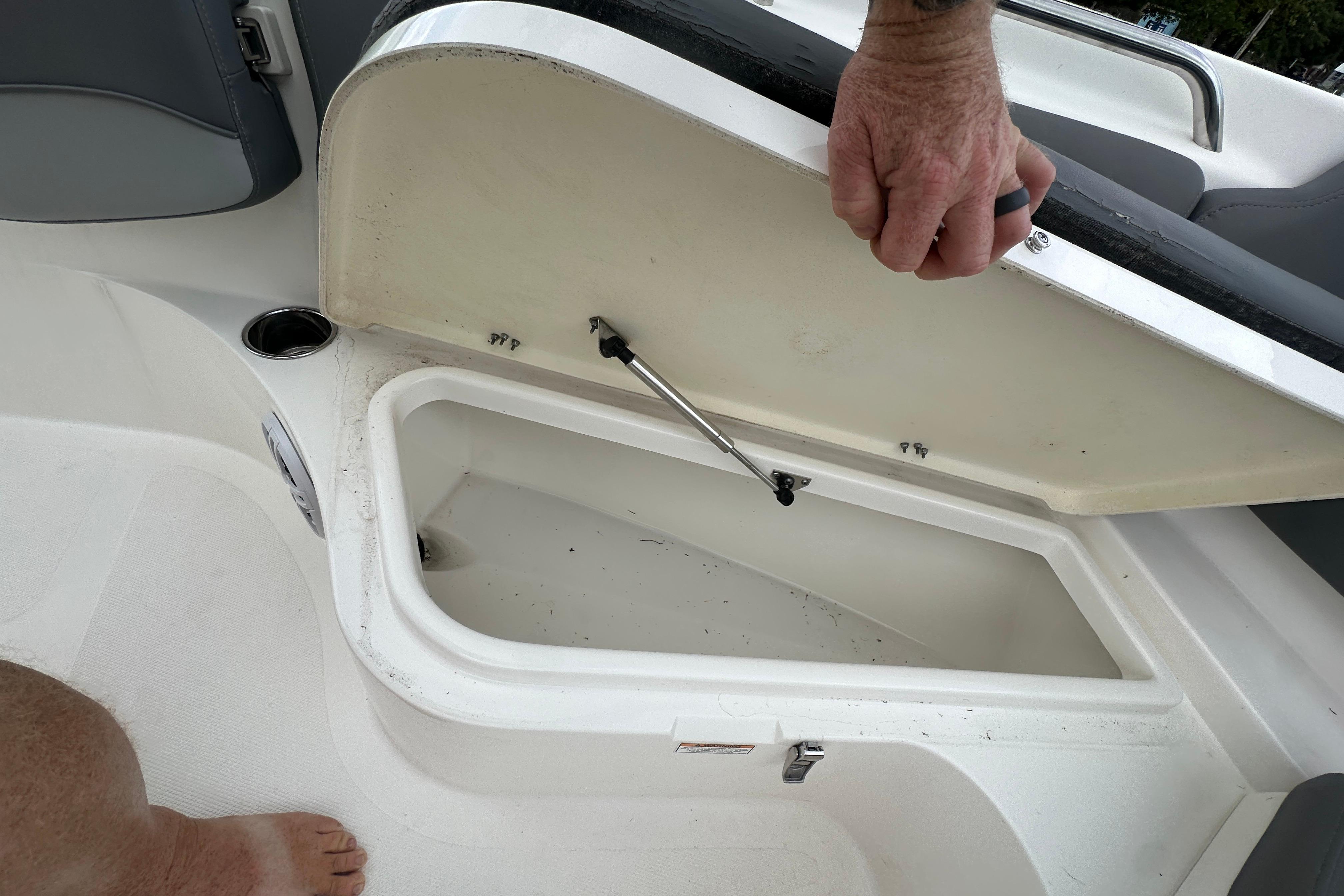 Open storage compartment on a 2023 NauticStar 2102 Legacy boat.